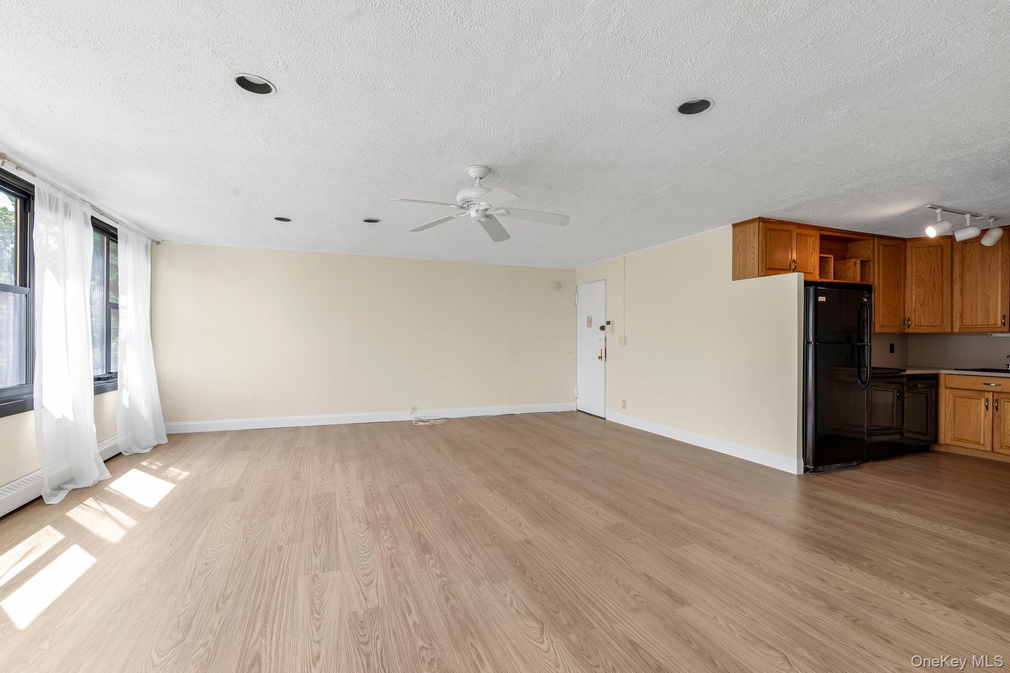 Move right into this newly renovated apt.  Eastern exposure offers direct sunlight entering the home with wall of windows throughout.  Kitchen has chestnut cabinets, black glossy appliances with new flooring.  Brand new bath with storage galore, new vanity, recessed lighting, flooring with subway tiles in shower that includes glass doors.  Brand new custom laminate flooring in every room.  Drapes surround each window for a modern appearance.  Prime parking space available for transfer.Lehavre ofers pool, tennis, gym, clubhouse and cafe