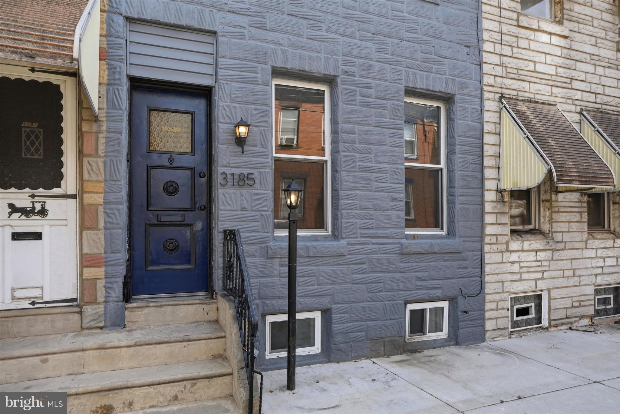 **STYLISH 3 BED/1.5 BATH IN PORT RICHMOND WITH FINISHED BASEMENT AND PATIO** This home is modern, fresh and full of details that make it special and unique. Exposed brick, reclaimed wood decorative wall and original iron railings: Check! Enter to the open living and dining floorplan just awaiting your personal furniture arrangement. A remote operated fireplace creates a cozy atmosphere and a nice base for your mounted TV (mounted holes pre-drilled). There is a bright modern half bath with wood vanity for ease of entertaining and daily life. The kitchen is a true standout with navy and white cabinets, gold fixtures, stainless steel appliances and counterspace galore! Beyond the kitchen is a good sized fenced in patio with level concrete ready for a grill, table, chairs and planters. Create your outdoor retreat! Upstairs are 3 true bedrooms with nice closet space, bright windows and a full hallway bathroom with sleek tile, shower/tub combo and light up vanity mirror. As a bonus the basement is mostly finished and provides additional space for a den, home office or whatever you envision. Located 1 block from Aramingo Avenue and near I-95 this home is close to everything you need and just a short distance to all else the City offers. Schedule your showing today or call for a private tour!
