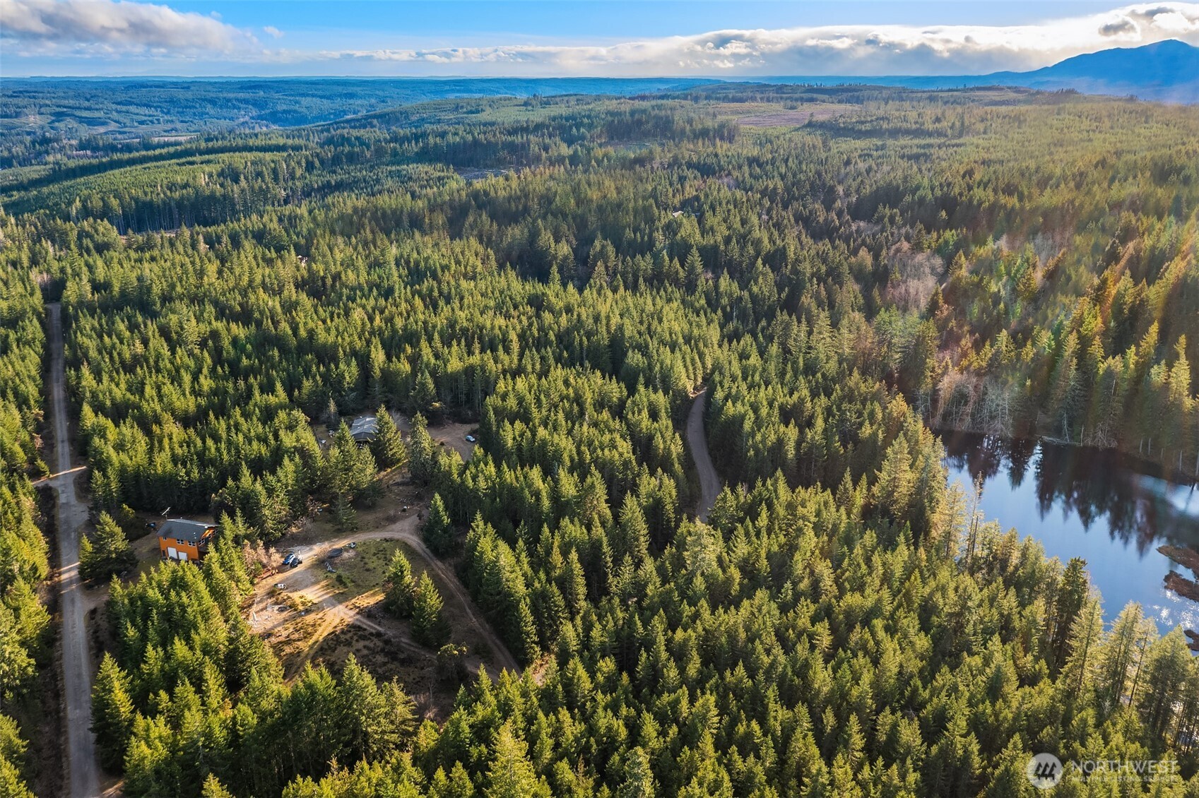 Over 27 Acres of Private Bliss with Lake Frontage & Mountain Views. Discover more than 27 acres of serene, private land featuring partial lake frontage and breathtaking views of the Olympic Mountains and Mount Rainier. Nestled within a gated community, this unique property offers exceptional potential for those ready to bring their vision to life. The estate includes two separate homes, each with its own septic system: Main Residence: 2 bedrooms, 2 bathrooms, situated above a triple-oversized garage. A true fixer with endless possibilities.Second Home:3 bedrooms, 2 bathrooms, covered porch, and fully fenced yard. This home sustained fire damage and has been completely gutted—ready for a full renovation and your custom design. Enjoy unlimited recreational opportunities right outside your door—boating, fishing, biking, and nearby horse trails. Despite its peaceful setting, the property is conveniently located just 30 minutes from Silverdale, Bremerton, and Belfair. Sold as-is by the bankruptcy estate trustee.A rare opportunity to own acreage, water access, and mountain views in a prime location. Bring your contractor and imagination—this property is ready for its next chapter.