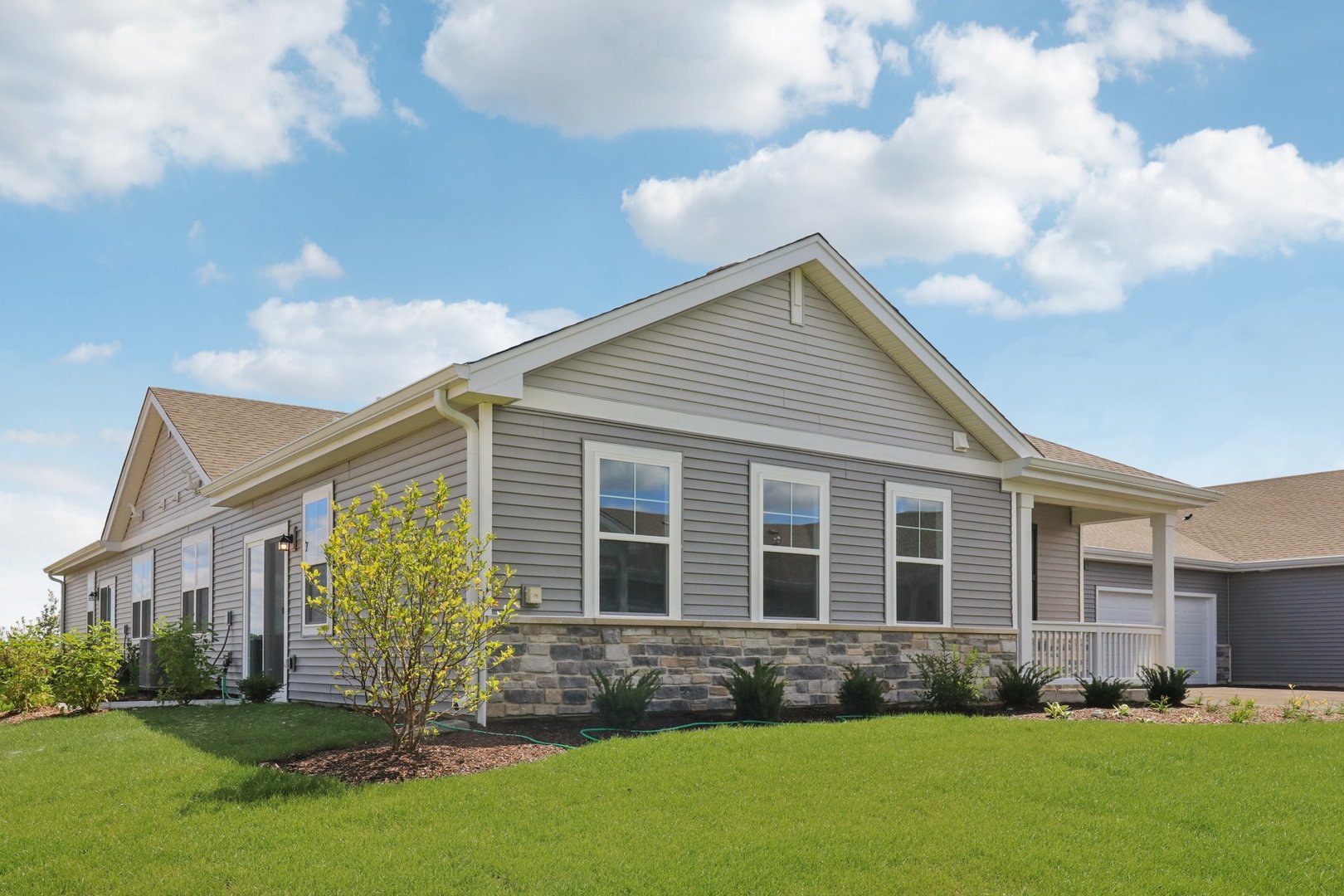 Envision yourself at 1057 Williamsburg Street  in Pingree Grove, Illinois, in a beautiful new low maintenance ranch townhome in the Cambridge Lakes North community. This ranch townhome will be ready for a Winter Move-In! Homesite includes fully sodded yard and patio. The Callihan plan offers 1,360 square feet of living space with 2 bedrooms, 2 baths, and 9-foot ceilings. Enjoy the Callihan's open concept Living room, Kitchen, and Dining area that's a great space for all your entertaining needs! Your kitchen features designer cabinetry, stainless steel appliances, pantry, and large island with eating bar. Enjoy your private get away with your spacious primary bedroom, and en suite bathroom with raised height dual sink vanity, and walk-in shower. All Chicago homes include our America's Smart Home Technology. Photos are of a similar home and model home. Actual home built may vary.