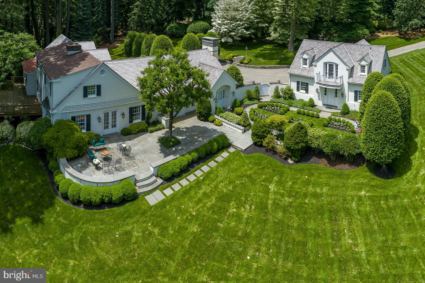 Extraordinary residential compound in the utmost private location, with a long, elegant tree-lined drive and remarkable grounds of nearly three acres with gorgeous views. Located on one of Villanova's most exclusive and sought after cul-de-sacs, timeless landscape architecture enhances this classic Main Line setting which began with a pedigree from the renowned Philadelphia residential architect, Walter Durham.Enter the front door to the tiled entrance foyer, with 'straight thru' views and abundant natural light.  Foyer opens to a gracious transverse center hall, with a traditional colonial floor plan, and flows to the formal living room, dining room and library, all with beautiful, random-width hardwood floors.  Foyer flows to the fabulous butler's pantry and wet bar, which open to the magnificent kitchen and great room addition. Enter the  white on white island kitchen, which opens fully under a lighted, parabolic archway to the great room with fireplace. Kitchen and great room have double doors out to the flagstone patio and courtyard garden.  Kitchen has pretty hardwood floors, double wall ovens, Sub Zero refrigerator, electric cooktop, twin sinks at a double corner kitchen window with astonishing views out over the patio, and green, granite countertops.  There is a small kitchen desk with seating with built-in shelving units for printer.Relax in the sun-filled adjacent great room with unique architectural design and wonderful open flow off the kitchen with vaulted ceiling, gas fireplace, flat screen TV with sound system, beautiful millwork, moldings,  hardwood floors, views of the private drive and stunning landscaped grounds. It is here where classic luxury is felt and lived but is never showy. Main floor owners' bedroom suite is just off the library and hall, pronounced by the lighted rotunda. This beyond-first-class, ultra-private luxe suite has H/H bathrooms, extensive closet systems, a walk-out door to the raised deck, and hideaway access to the Library and fireplace for true, one-level living at its finest.Just off the entrance hall foyer are the stairs to the second floor landing. Here are three bedrooms, generous in size and scale. The first bedroom has an en suite full tile bathroom, closet and pretty windows. Bedrooms two and three share a full hall bathroom.The walk out, partially finished lower level is currently in use as a WFH office and sitting area with WTW carpeting.   Office connects to the full laundry room and to storage and mechanicals rooms. Mechanicals include a whole house, back -up electrical generator power system. House has twin LP gas tanks, above-ground, for the gas fireplaces.The jewel box apartment over the heated, detached, three car garage is immaculate. Steps up to the landing have kitchenette and dining area, sitting area and full bath, along with French doors out to the Juliet balcony, with sensational views and then the sunny bedroom area, with more pretty windows. Apartment has all first class finishes, cabinetry and appliances, built-ins, hardwood flooring and white carpeting, just adorable.