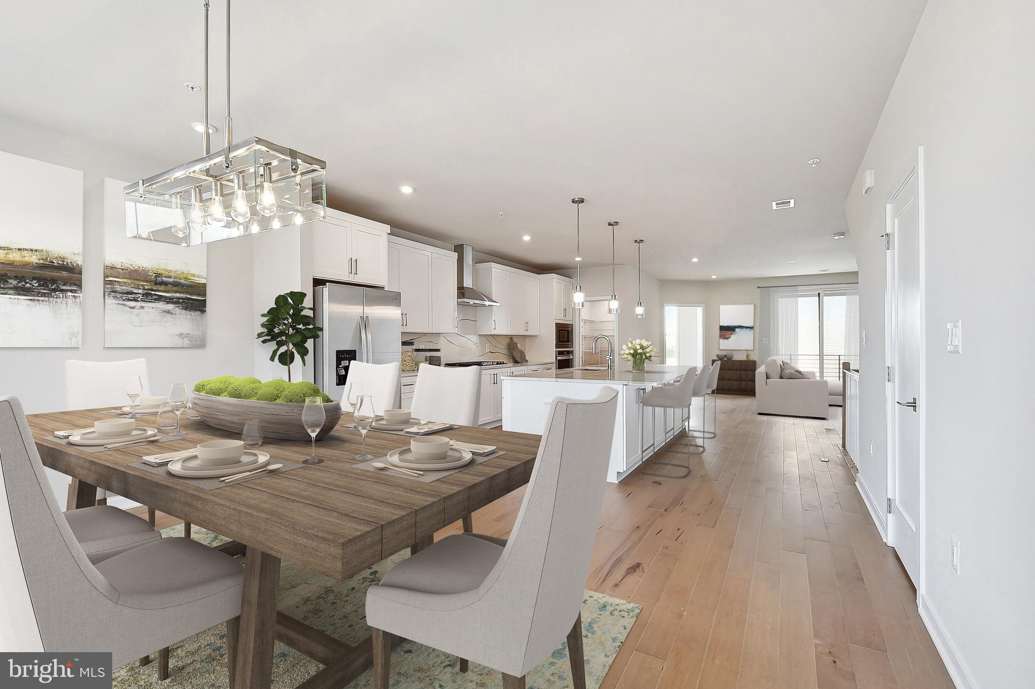 Steps from Ashburn Metro | The Walney Greensboro – Move-In Ready October 2026Discover contemporary elegance and everyday convenience in the Walney, ideally situated just a short walk from the Ashburn Metro Station. This 3-bedroom, 2.5-bath, one-car garage home is located within a vibrant community featuring exceptional amenities, including a resort-style pool, state-of-the-art fitness center, stylish clubhouse, and playground—offering the perfect blend of lifestyle and location.Designed with a warm contemporary aesthetic, the home showcases thoughtfully curated finishes and designer details throughout. The gourmet kitchen features bright white cabinetry, quartz countertops with a matching full-height backsplash, a coordinating white center island, and warm brass hardware. Premium KitchenAid stainless steel appliances complete the space, delivering both style and performance. The adjoining dining area includes a convenient butler's pantry with an additional sink and extra cabinetry for enhanced storage and entertainment.Upstairs, the serene primary suite is highlighted by a tray ceiling, spacious walk-in closet, and a spa-inspired bath with dual vanities and an oversized shower. A well-appointed laundry room on the bedroom level adds everyday convenience with a Whirlpool front-load washer and dryer, upper cabinetry, a utility sink, and quartz countertops.The expansive northwest-facing rooftop terrace offers the ultimate outdoor retreat—ideal for entertaining, dining under the stars, or simply relaxing while taking in panoramic neighborhood views.Additional highlights include an open oak staircase and wide-plank luxury vinyl flooring throughout the home.