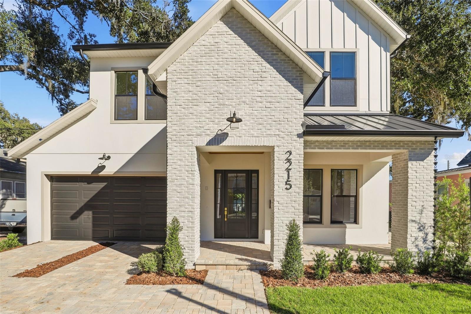 Meticulously designed by Fortis Enterprises, this custom 4BD/3.5BA residence with an office and a first-floor primary suite is nestled in the heart of highly desirable College Park. Step inside to find 10-foot ceilings on both levels, rich hardwood flooring, solid-core doors, and a welcoming front porch accented with pavers, a metal roof, and a tongue-and-groove ceiling. The gourmet kitchen is a showpiece, featuring quartz countertops, solid wood soft-close cabinetry, under-cabinet LED lighting, a spacious island, walk-in pantry, and premium Thermador appliances. A separate dining area, bathed in natural light, creates the perfect space for gatherings. The primary suite is a private retreat with a spa-like bath offering dual vanities with quartz counters, a soaking tub, a frameless glass shower, and direct access to an oversized laundry room and generous closets. Upstairs, three bedrooms include one with a private en suite and two that share a dual-vanity bath, along with a large bonus room ideal for work, play, or relaxation. Enjoy indoor-outdoor living on the oversized lanai with its newly built summer kitchen and stained tongue-and-groove ceiling. Additional highlights include: unfinished attic storage, a high-efficiency HVAC system, tankless water heater, termite bond, and builder warranties (1-year workmanship, 10-year structural). The Sherwin-Williams exterior paint system is backed by a 10-year warranty. Schedule your private tour today and experience this home for yourself!