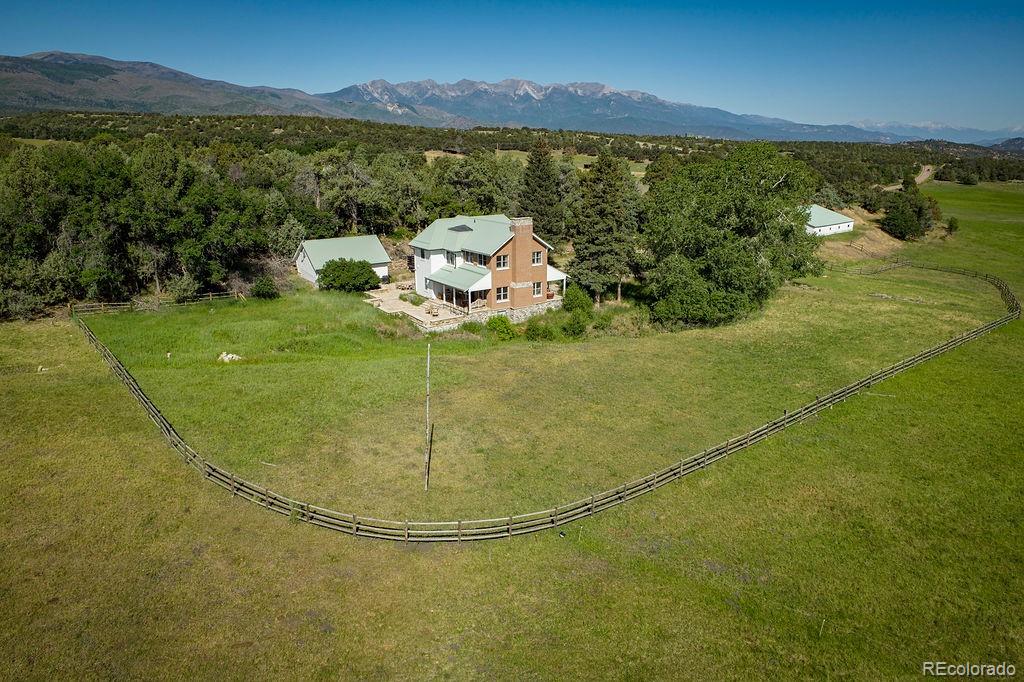 170 acre Colorado ranch for sale near Salida, Colorado.  Spring Valley Ranch, Cotopaxi, Colorado.  The 4,806sf home is a blend of history and modern updates with quiet and comfortable living space indoors and out.  Kitchen includes plenty of cabinets and counterspace, an AGA Classic 60 inch cast iron induction oven/range, and a Sub Zero refrigerator and an attached dining room.  Upstairs master suite is bright and spacious featuring two walk in closets and a large five piece bathroom.  There are two bedrooms on the main level and another upstairs bedroom well separated from the master suite.  Basement includes a large laundry room, bonus room, and space for future improvements.  Bordering a 640 acre State Land Trust section and thousands of acres of BLM, Spring Valley Ranch is a lush oasis at the base of the towering Sangre de Cristo Mountains in central Colorado.  Elk, deer, and turkey are prevalent on the property which is located in an over the counter elk unit.  70 - 80 acres of the ranch have historically been irrigated for hay production and grazing and are currently leased to a neighboring ranch for grazing.  The property is conserved by the San Isabel Land Trust to protect the tradition of ranching and wildlife on the ranch.  Seller purchased an adjoining 35 acre parcel with a well in place for future development outside of the conservation easement.  This parcel is heavily treed and exceptionally private.  Amenities are nearby: 29 miles to Salida, 37 miles to Canon City, 18 miles to Westcliffe.  For coming and going it's a short 85 miles to Colorado Springs Airport, 166 miles to Denver International Airport.
