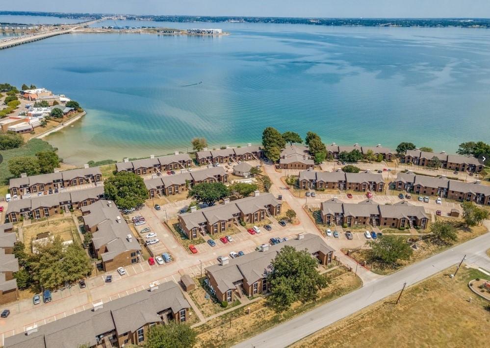 Rare investment opportunity to acquire a 22-unit portfolio in a lakefront community on Lake Ray Hubbard, offering substantial ownership within the HOA. The portfolio consists of 15 two-bedroom units and 7 one-bedroom units, with 20 units currently leased on 12-month terms, one unit leased month-to-month, and just one vacancy. Current monthly rental income totals approximately $30,170.75, providing strong in-place cash flow with additional upside through filling the vacant unit and future rent increases across several leases.The portfolio has also benefited from significant recent capital improvements. Most water heaters are approximately 1–2 years old, 7 units have HVAC systems approximately 1–2 years old, and roughly 80% of the units have received waterproof flooring within the past two years. Many units also feature recently replaced refrigerators.The HOA permits short-term rentals, providing investors with additional flexibility and the potential to generate premium rental income through alternative leasing strategies. Community amenities include gated parking and waterfront access to Lake Ray Hubbard, while the location offers convenient highway access and close proximity to Rockwall Harbor, shopping, dining, and other major retail destinations. School choice is another notable benefit of the location, with access to several highly rated schools and educational programs.With strong existing occupancy, long term tenants, immediate cash flow, recent improvements, rental upside, and flexible leasing options, this portfolio presents a rare opportunity to acquire significant scale within a single lakefront community.
