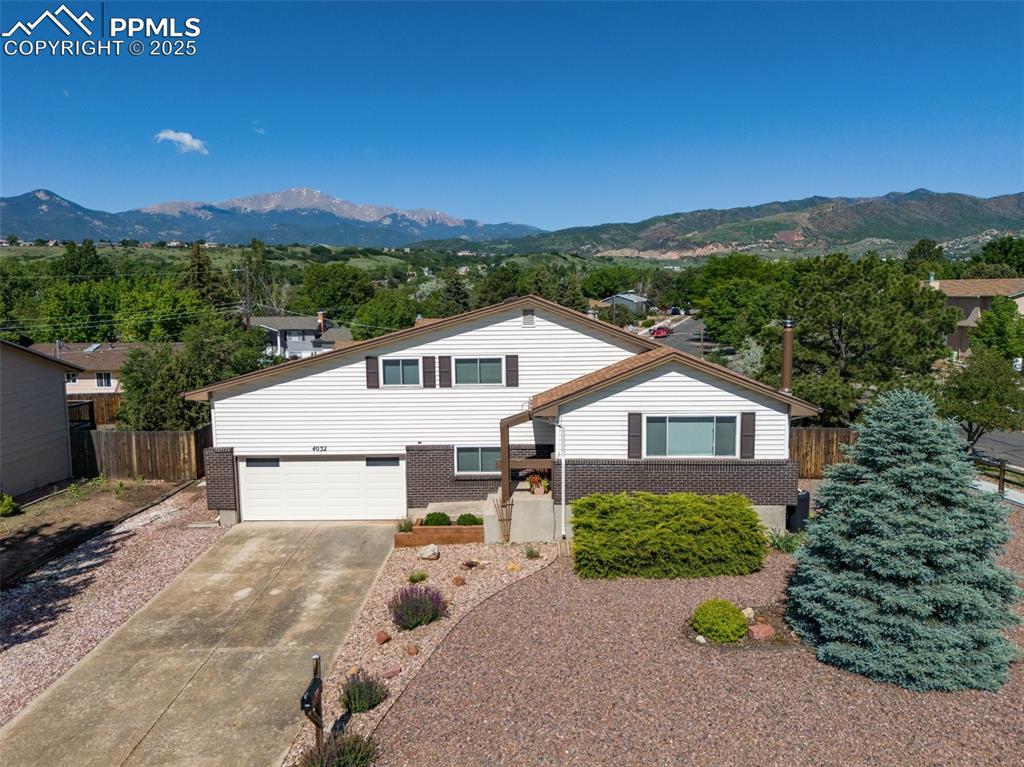 Spectacular opportunity on this updated and immaculate Holland Park home on a xeriscaped corner lot with PIKES PEAK VIEWS!! Just minutes from Downtown Colorado Springs, Garden of the Gods, hiking & biking trails, locally-owned businesses, restaurants and more, this Westside location can't be beat!! You'll love all of the recent updates, to include new luxury vinyl plank floors, a fabulous kitchen w/stainless appliances, a gorgeous island/breakfast bar w/quartz countertops, stainless steel sink, new faucet, and a coffee bar/island; beautifully updated full bathroom; newer carpet & tile; fresh interior paint; new lighting; a brand new central A/C system; a radon mitigation system; a Class 4 Hail-Resistant roof; a fabulous, manicured, yard and landscaping; and more! This home is sparkling clean and move-in ready! There are four bedrooms upstairs, each with new carpet, fresh paint, ample closet space and plenty of light. In addition to the living spaces that are included in the square footage calculations, there is a wonderful 238 sq. ft. "attic" space adjacent to bedroom 3 on the upper level! The lower/garden level features a family room/den, 3/4 bathroom, extra closet space, and the fifth bedroom. The basement space has so many uses! It could be a rec room, a large bedroom (there are TWO closets!), a workout room, or even a secluded home office. The wood stove helps keep this space super warm and cozy! The garage is oversized with plenty of space for your workbench or project area. There is plenty of off-street parking to include space for an RV! The 140 sq. ft. storage shed provides even more space for all of your tools, toys, and equipment! The same family has owned and cared for this special property since the 1970s. Come see this stunning home and make it yours!