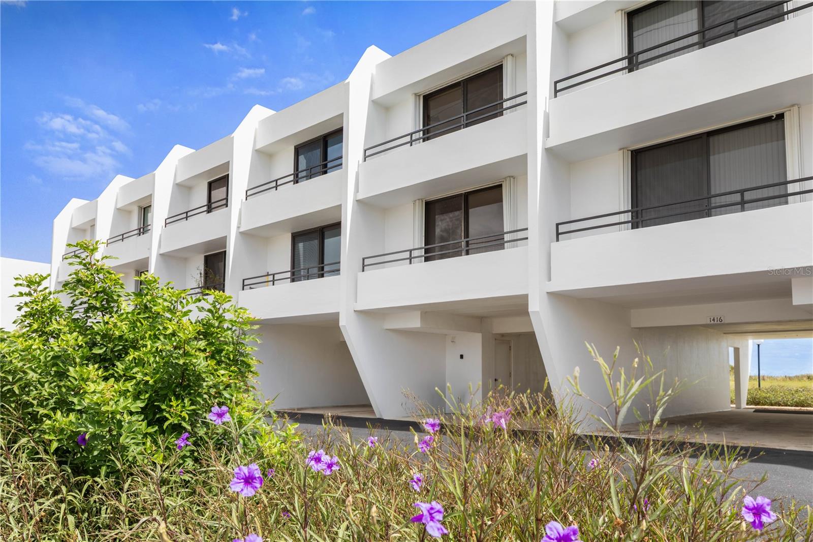 Steps from the sand with breathtaking ocean views, this beautifully updated Flagler Beach townhome offers the perfect blend of coastal style, comfort, and durability, and is available fully furnished for an easy, turnkey beach lifestyle!Wake up to gorgeous beach sunrises from the primary bedroom and living room, while the kitchen balcony and guest bedroom offer peaceful sunset views. The fully renovated kitchen features custom cabinetry, granite countertops, and stainless steel appliances, creating a stylish and functional space for everyday living and entertaining.This move in ready home has been thoughtfully updated with a recoated roof and new water heater in 2021, plus a new A/C system in 2025. Storm shutters are included, and the home’s thick poured concrete walls were built with coastal durability in mind.Enjoy the benefits of low maintenance beachside living without the same reserve requirements associated with condominiums. The HOA extends to the high tide watermark, helping preserve the beautiful oceanfront setting.Outside, a private covered carport and additional storage provide plenty of room for beach gear, bikes, or a golf cart. Cool off at the sparkling community pool just steps from your door, or head across to the beach whenever the mood strikes.Located in a golf cart friendly area, puts you minutes from Flagler Beach restaurants, local shops, the pier, and everything that makes this laid back beach town so special. With an HOA of just $650 per quarter and the opportunity to purchase the home fully furnished, this is an exceptional option for a primary residence, second home, or coastal getaway.Come experience the Flagler Beach lifestyle, ocean views, salty breezes, beautiful sunrises, and the beach just steps away!