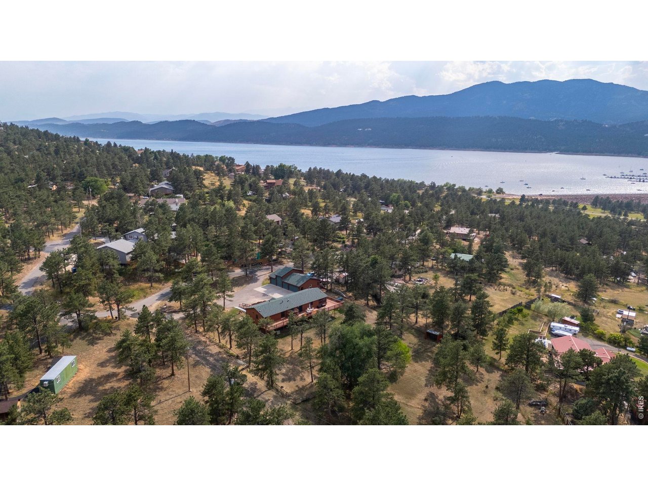 Open Saturday 3/21 from 11am-1pm! Nestled in the foothills of Loveland Colorado, this stunning home sits just a short walk from the coveted Carter Lake. Enjoy sweeping mountain views 4 bedrooms/5 bathrooms- including three Primary Suites-make it ideal for multi-generational living, a vacation retreat or simply a place to call HOME! The 1500sqf heated SHOP features a car lift, a 12ft. garage door and ample space for all of your toys! Pergo flooring, fresh paint, main floor laundry, and a fully fenced yard, your serenity awaits! With newer roofs, updated HVAC systems, and a whole-house generator, this home offers comfort and peace of mind! North Carter Lake isn't just a neighborhood; it's a lifestyle! Boating and fishing are right at your fingertips. All this just 15-20 minutes from Berthoud, Loveland, or Longmont!