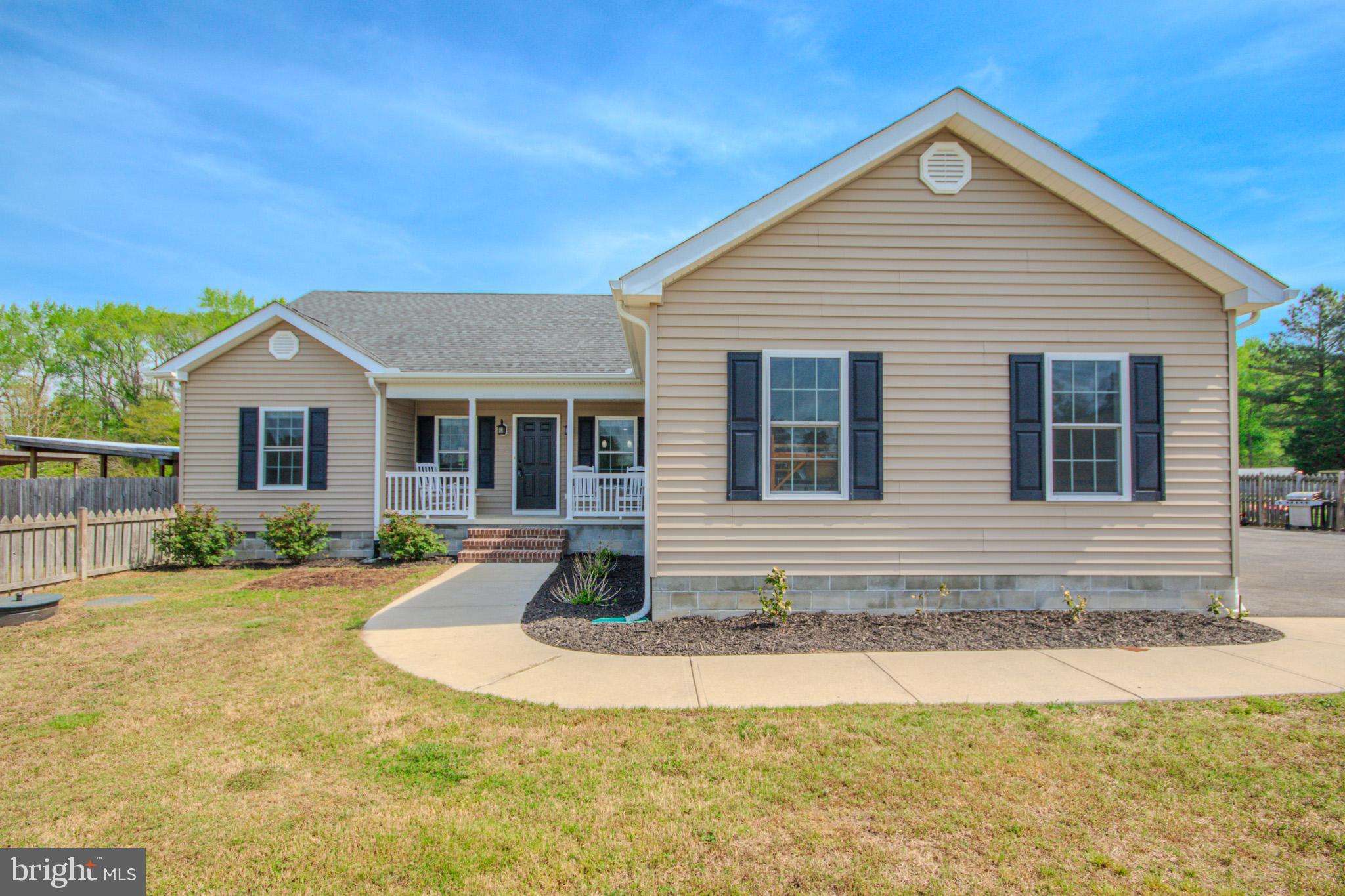 Welcome to 9243 Mill Branch Rd in Mardela Springs! A well-maintained 3-bedroom, 2-bathroom home offering 1,556 sq ft of comfortable living space and THREE full acres of land. Step inside to a living area that showcases vaulted ceilings and a cozy gas fireplace, creating an open and inviting atmosphere. The kitchen is equipped with tiled flooring, granite countertops, and stainless steel appliances, offering both style and functionality. The primary bedroom suite includes a walk-in closet and a luxury bathroom featuring a 6-ft Jacuzzi tub, separate tiled shower, and a double vanity with granite countertops. Two additional bedrooms are located across the living room and share a full bathroom with a tub and shower combination and a granite vanity. This property features 6-ft wooden fencing in both the front and backyard, providing privacy and security. Additional features include a utility room with washer and dryer, pull-down attic access for storage, and a finished garage with a mini-split system, ideal for a workshop, gym, or additional flex space. This home combines comfort, thoughtful layout, and desirable upgrades... Ready for its next owner to move right in! Schedule your private showing today.