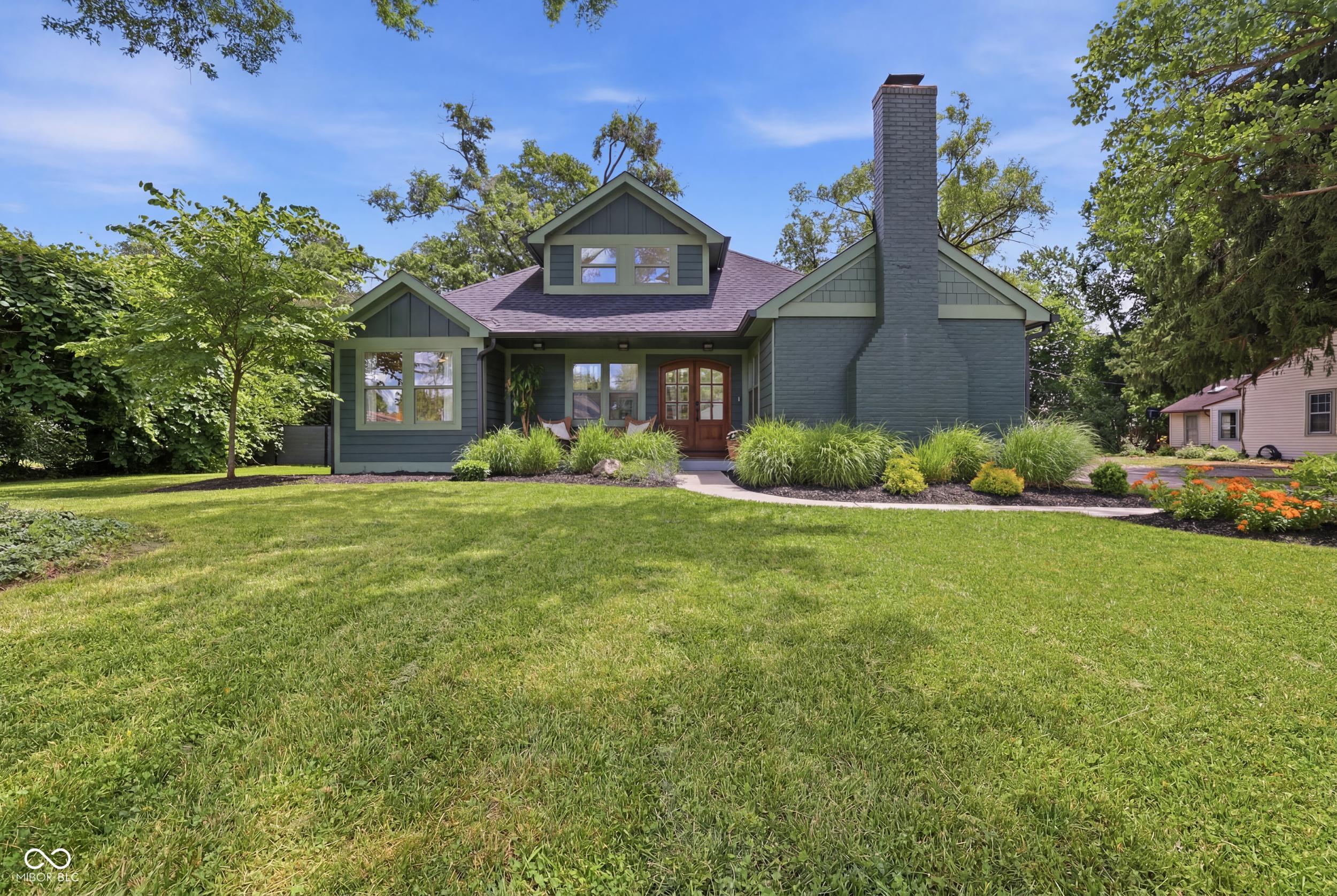 Set on a tree-lined street in the heart of Broad Ripple, 6185 Evanston is a study in considered luxury - a home taken down to the studs and rebuilt with finishes that reward a closer look, just minutes from the Monon Trail, the Village, and some of the city's best dining.  The double wood doors with beveled glass graciously welcome you to this iconic home.      Behind its charming facade, everything is new: roof, windows, and HVAC, with full smart-home wiring that puts lighting, climate, and security at your fingertips from a single control tablet. Inside, soaring ceilings and well-placed skylights pull natural light deep into the home, while custom cabinetry and custom tile frame rooms made for both everyday ease and elevated entertaining. The kitchen is anchored by artisan inset cabinetry built by hand, a built-in refrigerator set seamlessly into the line, and high-end appliances throughout. Quartz counters, beautiful custom pantry, and soaring ceilings make this kitchen a true show stopper.   The luxury primary suite is its own quiet retreat - soaring ceilings, skylights, beams, huge custom walk in closet, double vanities, a soaking tub set apart for long evenings, and a smart walk-in shower where the temperature is set before you step in. Custom-fitted closets bring order to every room, and the secondary and half baths carry the same finish, each appointed in custom tile. Two lovely additional bedrooms flooded with light, high end finishes, and custom closets. These features are normally found at much higher priced homes. Outside, a covered patio extends the living space into a stunning backyard oasis - completely private green space built for slow mornings and long evenings. An oversized two-car garage adds rare room for vehicles, storage, and the projects that make a house your own. Luxury, location, and lifestyle in rare alignment, in one of Indianapolis's most coveted neighborhoods. Schedule your private showing.