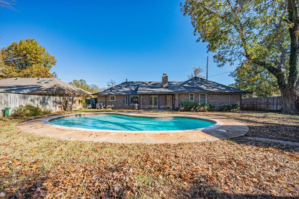 Welcome to 2704 S Berry Road, ideally situated just minutes from the University of Oklahoma, Campus Corner, and local shopping. This spacious 3-bedroom, 2.5-bath home offers a solid layout, generous square footage, and great bones — perfect for a buyer who appreciates character and wants the option to personalize over time.Inside, you’ll find multiple living areas, including a bright secondary living space filled with natural light and a main living room anchored by a cozy fireplace that flows into the kitchen and breakfast nook, all overlooking the backyard and inground pool. The kitchen features warm, original wood cabinetry, a walk-in pantry, and double ovens — offering both charm and a functional foundation that many buyers love and choose to preserve.The floor plan includes two secondary bedrooms connected by a Jack-and-Jill bathroom, an expansive primary suite with a private ensuite, walk-in shower, and walk-in closet, plus a sunroom that adds valuable flex space for a home office, gym, or creative retreat. Built-in storage throughout the home adds everyday functionality and timeless character.Outside, enjoy a large backyard with an inground pool and a powered workshop — ideal for entertaining, hobbies, or outdoor living. Additional features include a two-car garage, a convenient half bath near the garage entry, and a circular drive for extra parking.Recent exterior improvements include a **brand-new Class 4 impact-resistant roof, new gutters, and freshly painted trim and fascia**, offering peace of mind and strong curb appeal. This home presents an excellent opportunity to enjoy space, character, and location, with flexibility to update as desired. Schedule your showing today.