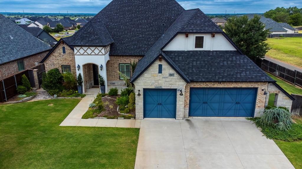 Simple luxury in Norman's Fountain View community. This beautiful home sits on top of the hill, with the most gorgeous views. Entertain on the spacious back patio from the outdoor kitchen, and enjoy Oklahoma's amazing sunsets. The well-appointed features in this elegant home include an 8' iron glass front door, beautiful statement lighting throughout, finely crafted built-in cabinetry, solid wood flooring upstairs and down with a natural stain finish, Marvin wood / fiberglass windows, spa-like primary bath with a soaking tub and walk-in shower, primary bed with his and hers closets and vaulted ceiling,  9'x4' decadent kitchen island, undercounter ice maker, coffee bar, Dacor gas cooktop in the kitchen, Wolfe oven, Coyote natural gas grill on the patio, walk-in storm shelter in the garage, epoxied garage floors, natural gas heater in the garage, central vac upstairs and down, beautiful gas fireplace with floor to ceiling stone, 4.5" wood shutters throughout the house, inground sprinklers, full guttering with rounded downspouts, and so much more. There is a very large "bedroom" upstairs with a full bath. This space can also be used as a theater or media room, an office, a guest suite, and more. There are also two walk-out attic spaces with copious amounts of storage. The spray foam insulation in this home keeps the attic spaces from getting too hot or too cold. Who needs rented storage, when spacious access is this easy? Fountain View under $750K doesn't happen often. Schedule your appointment today.