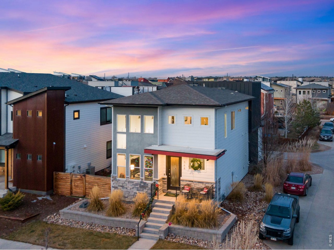Live the lifestyle you've always imagined! Stunning modern design meets unbeatable location in this exceptional home. Meticulously maintained and move-in ready, this corner-lot gem delivers luxury living at its finest. Entertain in style on your engineered rooftop deck - wired with 240V and built for a hot tub - where panoramic mountain views and breathtaking sunsets await. The professionally landscaped, fully fenced side yard is designed for low-maintenance outdoor living and unforgettable gatherings. Inside, the main level dazzles with engineered hardwood floors, soaring ceilings, and an open-concept layout anchored by a dramatic 3-sided fireplace. The chef's kitchen boasts white quartz countertops, custom cabinetry, full tile backsplash, and a walk-in pantry, all finished with modern designer touches. A barn slider leads to the mudroom and access to garage as well as sideyard. Upstairs, a striking black steel and stainless cable handrail guides you to a versatile loft - ideal for a home office or yoga studio - plus three bedrooms and two baths. The oversized primary suite features a walk-in closet, unique exposed ducting, and a spa-inspired bath with quartz tops, full-height white subway tile, and a large walk-in shower. Just steps from Old Town Fort Collins and New Belgium Brewery, PLUS directly across from the Poudre River Kayak Park and trail system - this location is truly unmatched! Coveted Old Town North is a lifestyle just waitng for you to join. As of 3/31/2026, Primary Short Term Rentals are an allowable use. Buyer to verify with City of Fort Collins.