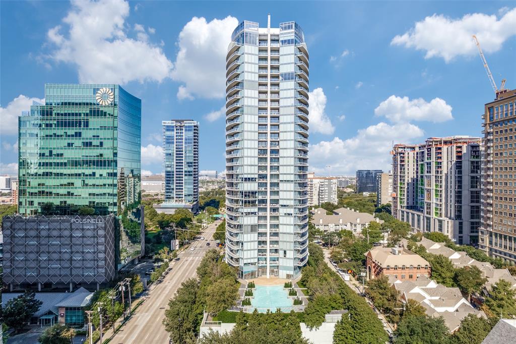 Perched high above the city at The Azure, this stunning two-bedroom, 2.5-bath residence offers an exceptional blend of sophistication, comfort, and breathtaking design. Floor-to-ceiling windows frame sweeping south-facing views of the downtown skyline, filling every room with natural light and delivering unforgettable sunsets. Designed for both everyday living and effortless entertaining, the open-concept kitchen, featuring premium Miele appliances and a built-in espresso maker, flows seamlessly into the family room, where the city skyline becomes your backdrop. Nearly every space in the home captures panoramic views, creating a truly elevated living experience. Rich hardwood floors extend throughout the main living areas and bedrooms, adding warmth and continuity to the home’s modern aesthetic. Step outside to two expansive covered terraces, ideal for relaxing or hosting guests. One features a cozy gas fireplace and overlooks the resort-style pool, offering a serene setting to unwind while enjoying the city lights. The primary suite is a private retreat, complete with a spa-inspired marble bath, soaking tub, separate shower, and a generous walk-in closet designed by California Closets. A thoughtfully positioned guest suite is located on the opposite side of the home. A rare highlight of this residence is the dedicated two-car garage, offering ample space for both parking and storage which is an uncommon luxury in high-rise living. Residents of The Azure enjoy a full-service, lock-and-leave lifestyle with 24-hour concierge, valet parking, a state-of-the-art fitness center, resort-style pool, sauna, community room, and business center. Ideally located in the vibrant Harwood District, this residence is just moments from premier dining, shopping, nightlife, and the American Airlines Center, placing the very best of the city right at your doorstep. This is luxury high-rise living at its finest, where modern elegance meets unmatched views and effortless convenience.