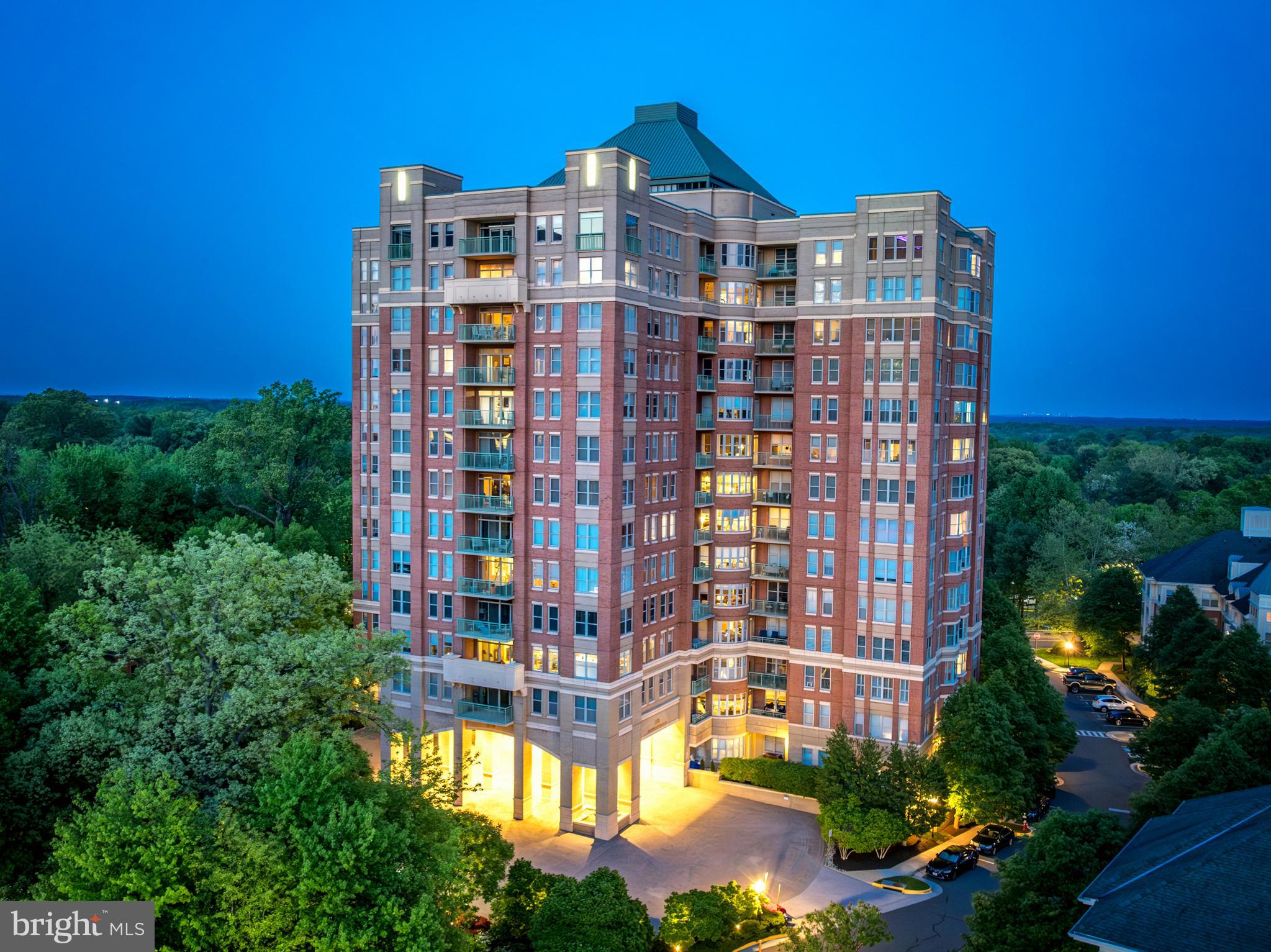 Welcome to Unit #1106 at Stratford House, one of Reston's most sought-after luxury condominium communities adjacent to Reston Town Center. Offering 1,775 square feet of beautifully maintained living space, this spacious residence features two bedrooms, two full baths, and a versatile den, all positioned on the building's most coveted view tier. Expansive windows frame breathtaking panoramic views of the Reston skyline, lush treetops, and spectacular eastern sunrises, while providing a front-row seat to Reston’s renowned Fourth of July fireworks display. The thoughtfully designed floor plan offers generous living and dining spaces ideal for both everyday living and entertaining. The kitchen features abundant cabinetry, granite countertops, stainless steel appliances, and a sunny breakfast area. The spacious primary suite includes two walk-in closets with custom built-ins and a well-appointed ensuite bath. Additional conveniences include a separate laundry room, two reserved garage parking spaces, and two storage units. Stratford House residents enjoy exceptional amenities including a concierge, fitness center, swimming pool, community room, electric vehicle charging stations, secure building access, and three elevators. Just steps from the W&OD Trail and Reston Town Center's premier dining, shopping, entertainment, and Metro access, this home offers an unparalleled combination of luxury, convenience, and lifestyle. Stratford House is known for its strong, well-managed condominium association and enduring commitment to maintaining one of Reston's premier residential communities.