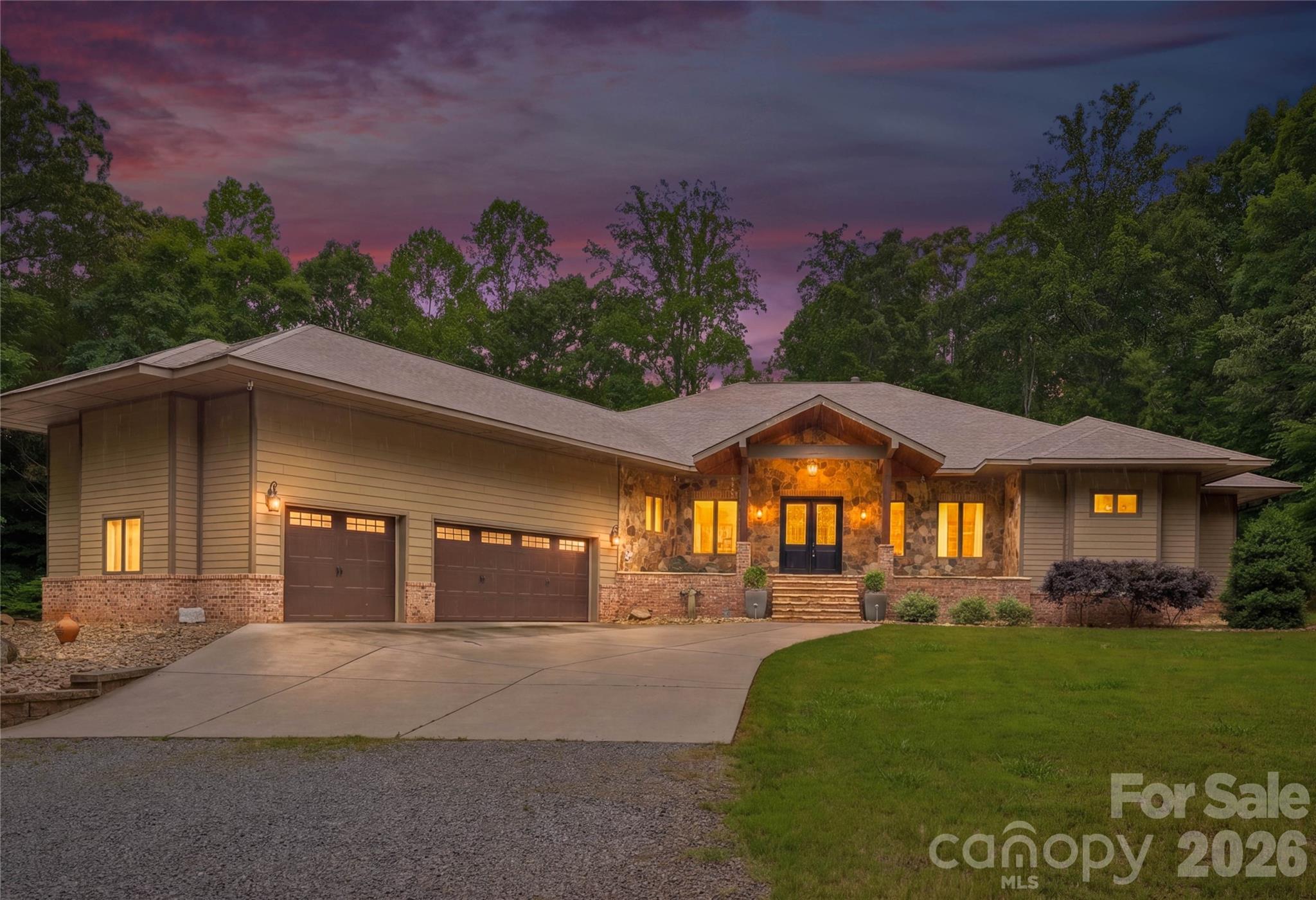 Welcome to 9860 Harvest Lane—an exceptional private retreat tucked away at the end of a quiet lane on 12.37 wooded acres, perfectly positioned between Mooresville, Davidson, Huntersville and Concord. Built in 2018, this custom home offers over 3,100 square feet of refined luxury living, plus an additional 3,100 square feet of unfinished basement space ready to be transformed into a recreation area, workshop, fitness studio, guest quarters, or ultimate storage for outdoor gear and equipment.  Designed with both comfort and entertaining in mind, the open-concept floor plan features a gourmet kitchen with a butler’s pantry, a spacious great room with a stunning stone fireplace, and a luxurious primary suite complete with its own stone fireplace, spa-inspired bath, and dual walk-in closets. Two additional bedrooms, two full baths, a private office, and a spacious laundry room provide both functionality and flexibility.  The numerous doors and windows across the rear of the home frames the true showpiece of the property—a spectacular covered porch spanning nearly 1,700 square feet and overlooking acres of serene natural beauty. Whether enjoying your morning coffee, hosting gatherings, or simply taking in the peaceful surroundings, this outdoor living space was designed to connect you with nature year-round.  For the outdoor enthusiast, this property is truly one of a kind. Explore your own wooded acreage, enjoy evenings around the custom stone fire pit, or take advantage of the private shooting range. The impressive 24’ x 16’ barn, built in 2023, features two levels, 9-foot ceilings, and electricity—ideal for storing ATVs, outdoor equipment, hunting gear, kayaks, or creating the perfect workshop or hobby space.  The expansive basement features soaring ceilings and houses many of the home’s premium mechanical systems, including a whole-home water filtration system, dehumidification system, radon mitigation system, electric water heater, and private well holding tank—offering you peace of mind along with exceptional utility and storage.  9860 Harvest Lane is more than a home—it's a private retreat designed for those who value space, privacy, and an exceptional lifestyle.