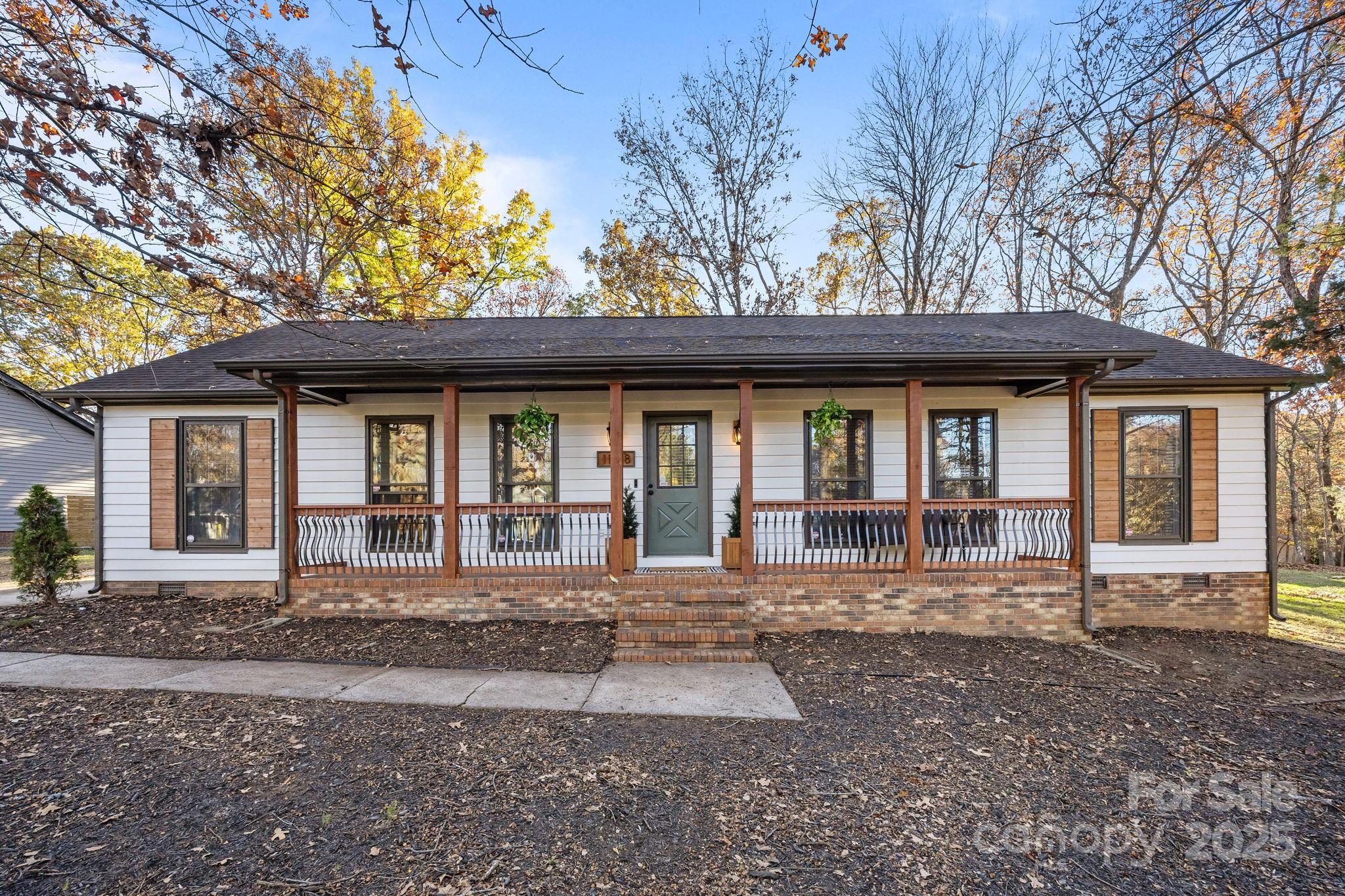 Nestled on a sprawling lot in Charlotte, NC, this stunning ranch home seamlessly blends Southern comfort with modern design. Beautifully updated throughout, this home is stunning. The formal living room features vinyl plank flooring, neutral paint and room for multiple seating areas. This room opens to both the great room and the formal dining room, which is currently being used as a home office. The great room features a wood-burning fireplace and flows seamlessly into the kitchen. This area is ideal for entertaining family and friends, or enjoying a cozy evening at home. The kitchen is sure to please the chef of the home ~ Stainless appliances, white cabinets, tile backsplash, solid surface counters, recessed lights, wine refrigerator, pendant lighting, oversized island with breakfast bar and a wood ceiling. The primary bedroom suite is a work of art, featuring a wood ceiling, Board and Batten accent wall and beautifully renovated primary bathroom with tiled shower, new vanity, lights, and tile floors. The primary suite also has a walk-in closet. The secondary bedrooms are spacious with good closet space. The secondary full bathroom has also been remodeled with stunning finishes. Venture outside to discover an outdoor oasis. The huge deck features multiple seating areas, a dining area, an area for grilling and for those evenings when you just want to relax and pamper yourself, a deep seated hot tub. But that is not all! A truly unique and impressive addition to the back yard is the renovated shipping container, providing an additional @ 320 square feet of space. This cleverly designed container has electric and has been transformed into two spaces. One side features huge windows and French doors, flooding this area with natural light. The other side has a garage door and a single door, with plenty of space for your projects. Use your imagination and create a space all your own ~ an office, art studio, workshop, garden space etc. This unique feature adds unparalleled value and character to the property.  The huge yard has two additional storage buildings, a play set, a fire pit area and space leftover for outdoor activities. 
This home is conveniently located to The Bowl, Ballantyne, I-485, restaurants, medical and shopping. Come and visit this home today and discover suburban serenity without sacrificing urban perks.
