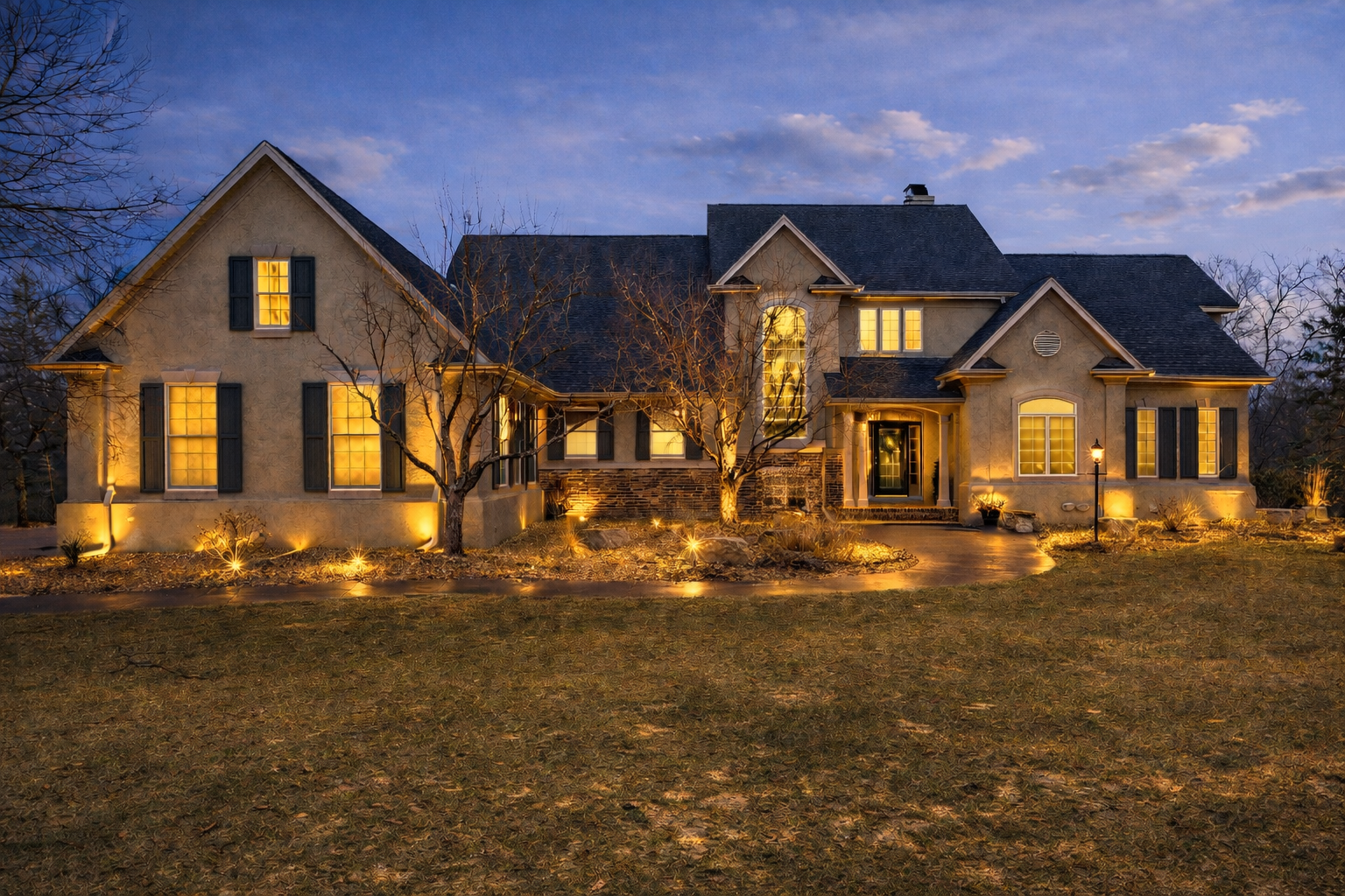 Enveloped by mature landscaping, this meticulously crafted home must be seen to experience its world-class comfort and timeless pleasure. Set on over 2 acres in the sought after Wynstone Neighborhood, this stately home makes a breathtaking statement. Once inside, you are greeted by an impressive two-story foyer with a fairytale staircase that leads into the first of many enjoyable spaces, whether it's the formal living room, centered by a fireplace and a bright wall of windows, the luxurious dining room with ample seating, the cozy sunroom, or the inviting great room off the kitchen. The layout is thoughtfully intuitive, planned for the demands of everyday enjoyment and entertaining. The chef's kitchen has Cambria countertops, high end appliances, and opulent details such as pull-out drawers, hidden spice racks, and a pot filler. Cooking in this kitchen is a dream. The main floor primary suite is a welcome respite with a lavish bathroom, enormous closet, and a private balcony overlooking the backyard.  A generous home office enjoys views of the front grounds, while the mudroom discreetly incorporates laundry, a bath, and a walk-in pantry. Upstairs, enjoy another bedroom with ensuite bathroom, and two additional bedrooms connected by jack & jill bathroom - all with walk in closets and luxurious finishes. The lower level is designed for gathering and hospitality, featuring a spacious family room that opens seamlessly to the outdoors, along with a guest suite and a fully appointed one-bedroom apartment complete with kitchen and private bathroom. The outdoors reveal an alfresco paradise with an outdoor kitchen that includes a pizza oven, heated inground pool, hot tub, commanding fireplace, and large, lush green yard. This home is an unparalleled opportunity to own something truly special.