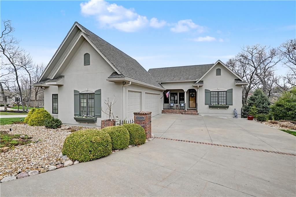 Tucked into a serene, wooded setting in the private gated community of Loch Lloyd is a charming reverse 1.5 story. Home offers a blend of warmth and functionality with 4 bedrooms and a versatile bonus room.  The main floor features 2 private bedrooms. Large windows throughout the home invite natural light. Kitchen is spacious with a large island a walk-in pantry. The lower level walkout expands the living space with 2 additional bedrooms and a bonus room which is perfect for a home office or gym. The lower level includes a large bar area and more. Step outside and you will find an incredible outdoor space with great landscaping, screened in porch, deck and covered patio.