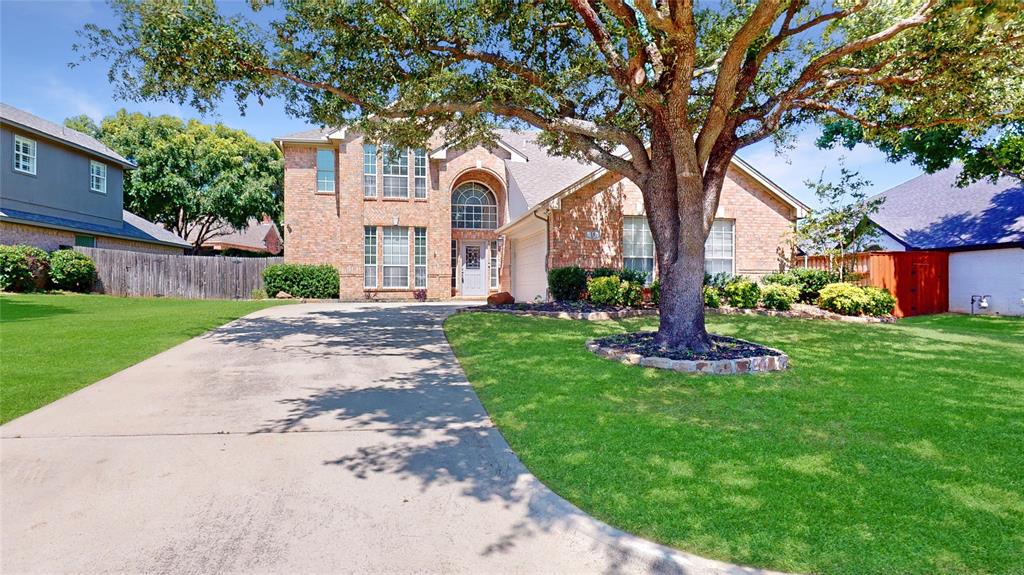 Light and bright 2-story in Trophy Club with beautiful brick elevation nestled beneath mature trees! Terrific location just a short distance from parks, tennis courts and Trophy Club Country Club, and only minutes from major highways and endless dining and entertainment options! Inside you will find 4 bedrooms, 2.5 baths, formal dining area, and 2-car garage! Upgrades and amenities include neutral paint tones throughout, split bedrooms for added privacy, spacious family room with towering ceilings, convenient built-ins, and a wall of windows looking onto the backyard patio, upgraded lighting fixtures, rich wood flooring throughout main living areas, cozy fireplace, and MORE! Gourmet kitchen boasts granite countertops with a subway tile backsplash, an abundance of cabinetry and counter space, stainless appliances with a gas cooktop, and eat-in area. Primary bedroom offers a luxurious ensuite with dual pedestal sinks, frameless double shower, and generously-sized walk-in closet. Three large bedrooms and a full bath round out the second level of the home. Private backyard is complete with an expansive covered patio area perfect for grilling and entertaining!
