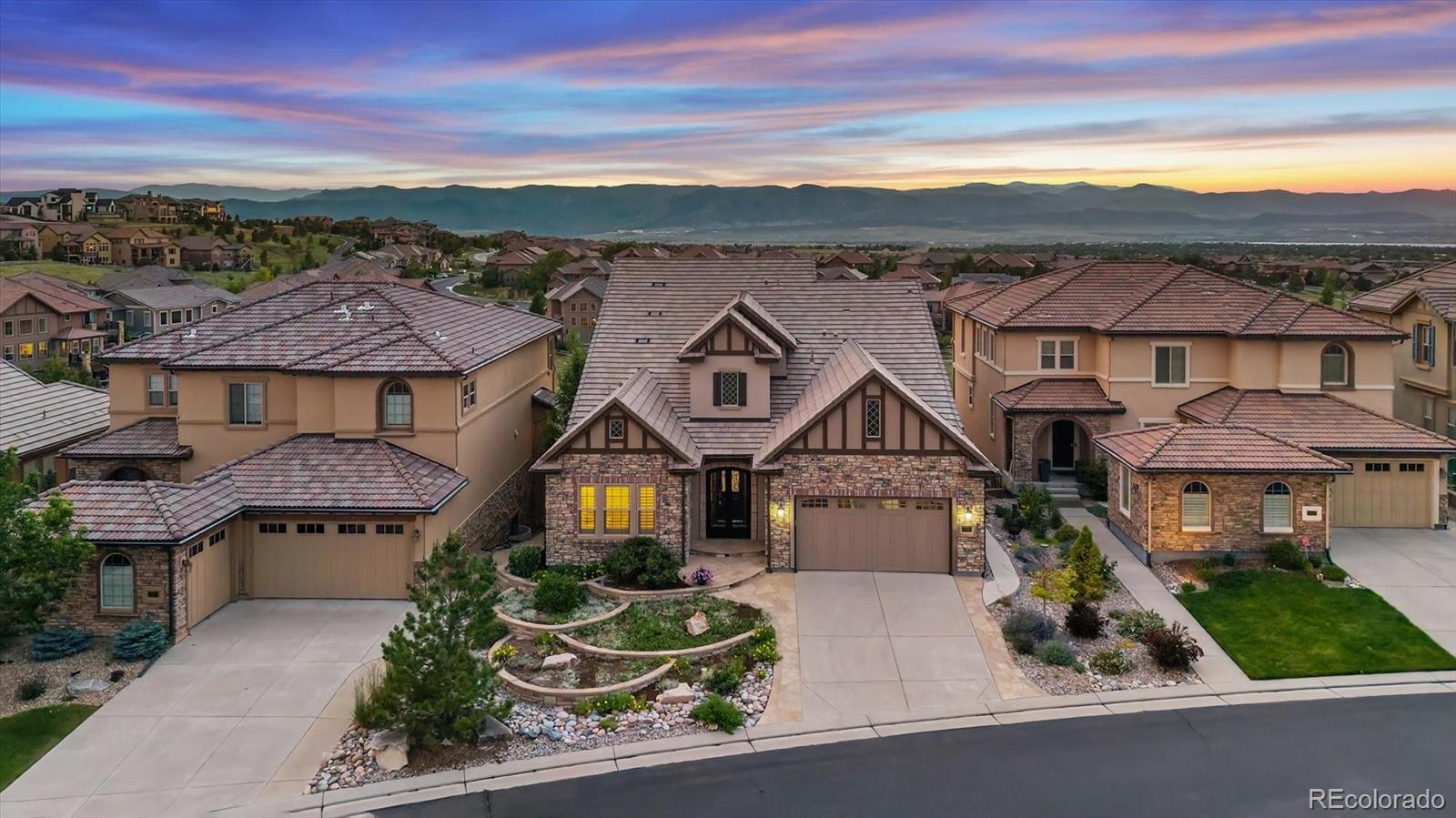 Spectacular, unobstructed panoramic mountain views from all three levels set this exceptional Backcountry residence apart. Whether enjoying morning coffee from the covered deck, relaxing in the main living areas, or entertaining in the walk-out basement, mountain vistas serve as the backdrop to everyday life. Positioned on a premium elevated lot that backs & fronts to open space, this home offers a rare combination of privacy & luxury. Truly unique main floor living ranch features 4 bedrooms, dedicated office, 5 baths & versatile loft w/full bath. Soaring two-story ceilings & expansive windows were thoughtfully designed to capture the incredible views. Luxury finishes include extensive hardwoods, custom tile work, wrought-iron details, plantation shutters, remote-powered shades, custom built-ins (family rm, office, loft), 4 gas fireplaces. Gourmet kitchen  boasts upgraded cabinets w/pull-outs, over/under lights, granite counters, stainless steel appliances, massive island, walk-in pantry & breakfast nook w/access to the covered deck. Spacious family room & primary suite both showcase the stunning views. Primary retreat also features oversized walk-in closet & spa-like bath w/jetted tub & steam shower. A grand dining room, private office, bed 2, full bath, guest 1/2 bath & laundry room w/cabinets & sink complete the main level. Loft offers more mountain views, perfect space for office or retreat. Finished walk-out basement has expansive multi-use spaces, beds 3 & 4 (current fitness room), full kitchen & wet bar, wine closet & access to outdoor living areas, all positioned to enjoy the remarkable views. An expansive patio, built-in gas fireplace, gas fire pit, waterfall & swim spa create an outdoor oasis framed by breathtaking views. Two oversized storage rooms & finished 3-car tandem garage w/cabinets, workspace, accessibility ramp. Live the extraordinary Backcountry lifestyle, perfected by a private clubhouse, pools, fitness center, trails & year-round events.