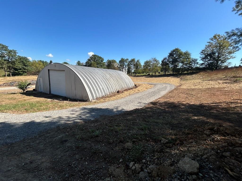 This 4.4 acre tract  already has a well and multiple septics on the property and would make a great homesite with a view. Property has a 2000 sq ft Quonset hut and a 2 car garage both with electric and concrete floors. The 4.4 acres is divided into 6 lots.  All lots have septic hookups and water. The property has 4 septics and a well to supply water to all tracts. Could be sold off separately or kept as an investment opportunity with rentals on each. To top it off, this property has an amazing view and no close neighbors.