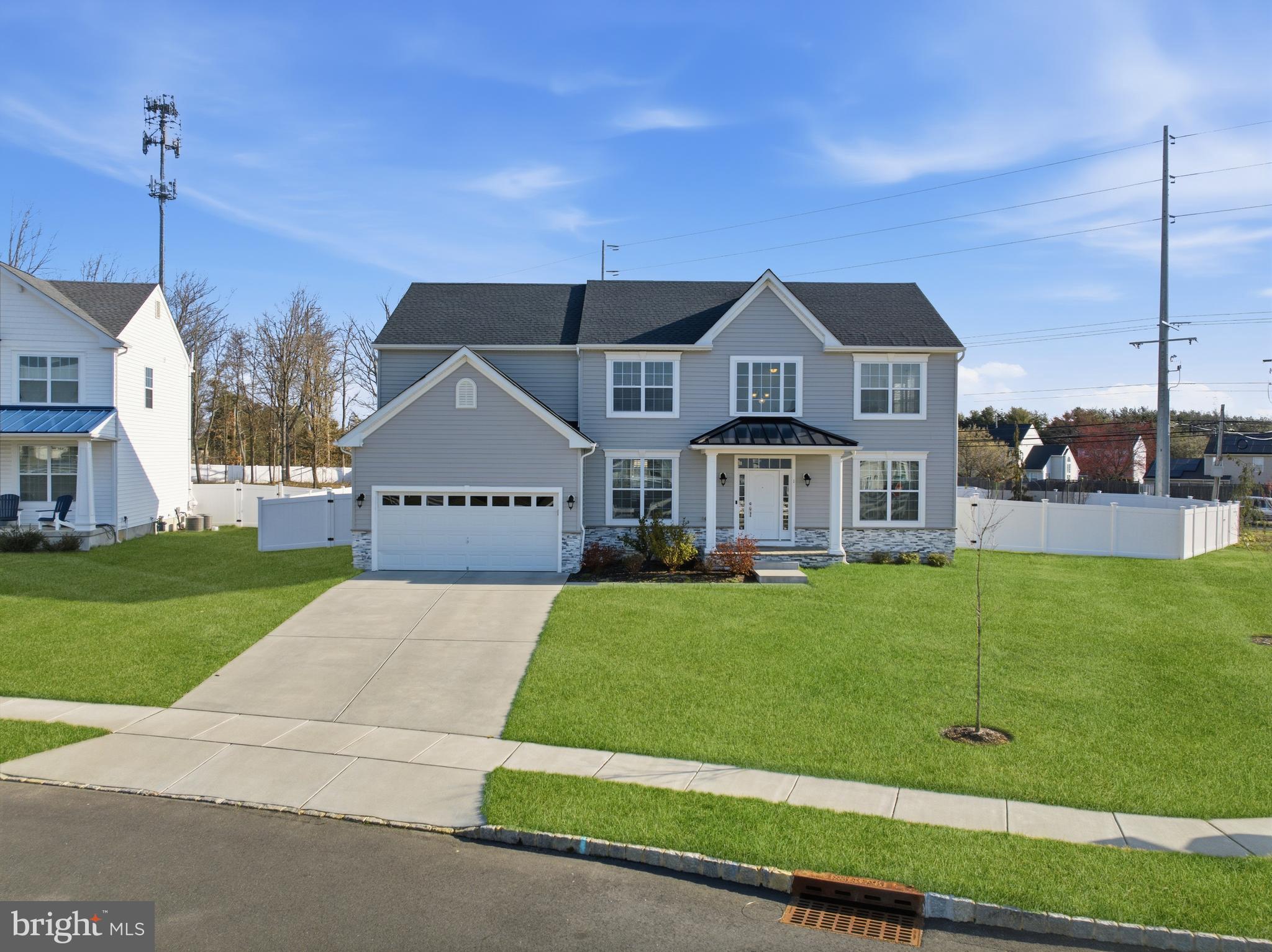 Welcome to this beautifully upgraded, like-new Belmont-Traditional in the highly desirable Estates at Lakeside in Gloucester Township! Just 3½  years young, this home effortlessly blends modern style, quality finishes, and everyday functionality.Situated on a premium corner lot, this 4-bedroom, 2.5-bath home is fully enclosed with an 8-foot privacy fence—featuring two standard gates and a convenient double gate along the side of the home—creating the perfect setting for your dream backyard oasis. The property is also equipped with a full sprinkler system covering the entire yard, making maintenance effortless.Step inside to a dramatic 2-story foyer and enjoy the seamless flow of the open-concept layout, ideal for both everyday living and entertaining. The home is enhanced with recessed lighting throughout and a full alarm system covering every door and window, along with a Ring camera for added security and peace of mind.The heart of the home is the expansive kitchen, featuring an extended island, elegant marble countertops, and stylish pendant lighting overhead—perfect for gatherings of any size. The kitchen opens to a spacious family room, while a formal dining room and living room provide additional space for entertaining and everyday living.Upstairs, you’ll find the convenience of second-floor laundry along with four generously sized bedrooms. The primary suite is a true retreat, highlighted by a beautiful cathedral ceiling, a walk-in closet with automatic lighting, and a private en-suite bath complete with marble countertops, a soaking tub, and a separate shower. Three additional oversized bedrooms and a full hall bath also feature upgraded marble finishes.Additional highlights include an upgraded tankless water heater, a 2-car garage, a flexible first-floor space ideal for a walk-in pantry or home office, and an insulated unfinished basement offering endless possibilities—create a gym, media room, or additional living space tailored to your needs.This home truly checks all the boxes—modern, upgraded, and move-in ready—all in a desirable community close to shopping, dining, and major roadways.