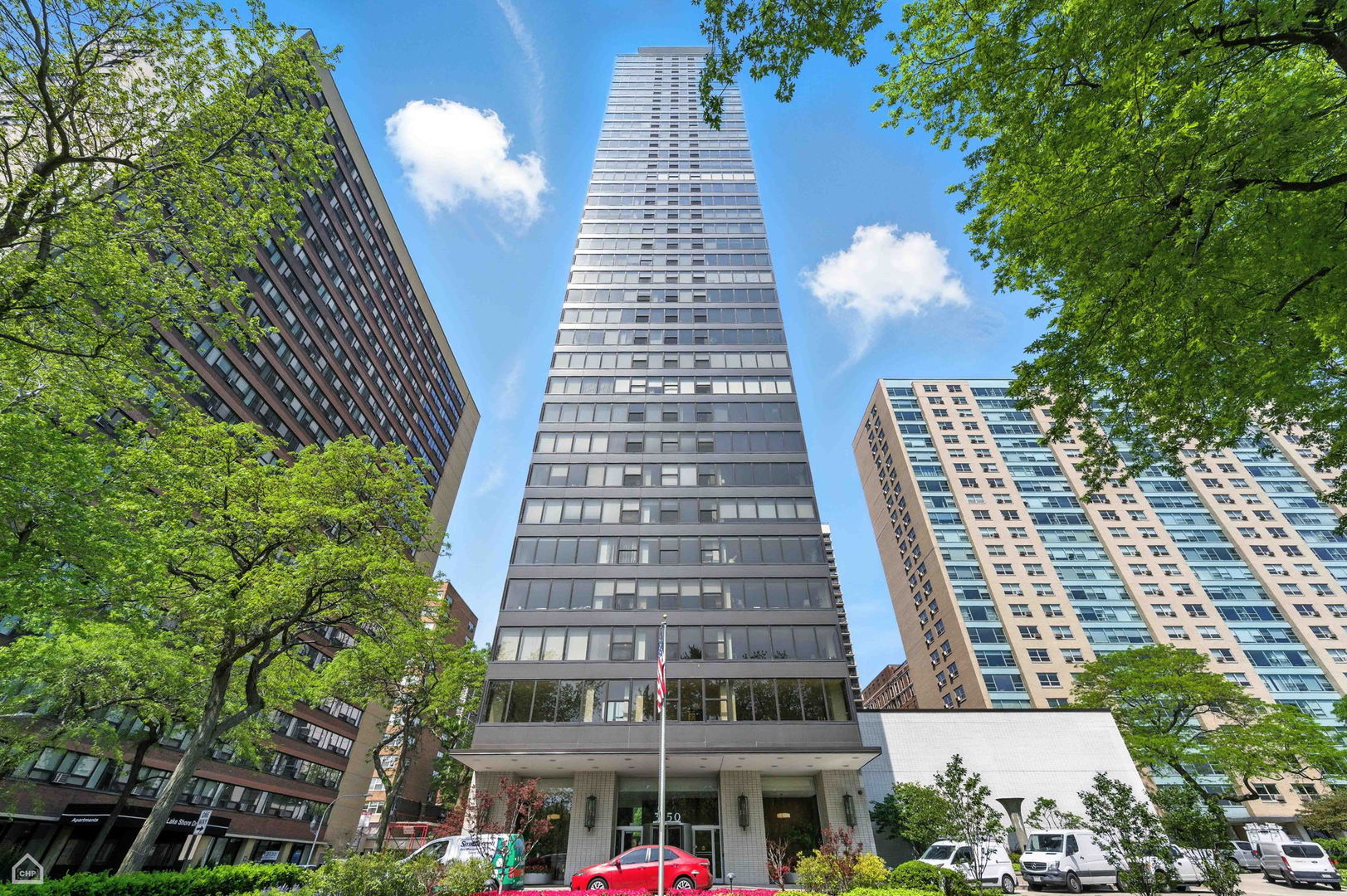 Step into elevated city living with this exquisitely renovated corner unit-a 2,200 sq ft, 3 bedroom / 2.1 bathroom home offering sweeping lake and skyline views in one of Lakeview East's most sought-after full-amenity towers. This sun drenched residence has been thoughtfully redesigned to blend timeless sophistication with modern comfort and now features a comprehensive list of premium upgrades throughout. The expansive living and dining area offers endless options for entertaining and lounging, enhanced by refinished dark hardwood floors, new dimmable light fixtures, and entirely repainted interiors. The newly reimagined chef's kitchen is the true centerpiece of the home-featuring a new Kitchen Island with built-in cabinets, custom white ceiling-height slow-close cabinetry, sleek new white quartzite countertops, new under-cabinet lighting in both the kitchen and dining area, two wine refrigerators, and a suite of brand-new high-end appliances including a refrigerator, induction stove with double oven range, and dishwasher. An elegant extension off the dining area offers additional cabinet space with integrated lighting, reminiscent of a scullery, creating a seamless flow for hosting or everyday living. All three spacious bedrooms offer generous closet space and spectacular views. The primary living area offers stunning sunset views to the west and serene northeast views of the lake, creating a truly tranquil retreat. For added comfort and sophistication, powered blackout shades have been installed, combining functionality with modern luxury. Each of the home's bathrooms has been modernized to reflect today's design preferences and now include a new wall-mounted sink in the powder room, and updated dimmable lighting fixtures. The home is outfitted with new custom doors, handles, and knobs, new base and crown molding throughout. All closets feature premium Container Store organizers, and light filtering. Located in a secure building with just two units per floor via four private elevator banks. Amenities include 24-hour door staff, outdoor pool, sundeck, fitness room, library, hospitality/play room, receiving room, bike storage, and additional storage that comes with the unit. Valet parking is also available for an additional monthly fee. Perfectly situated near the lakefront, parks, shopping, dining, public transportation, and within the Nettelhorst and Lakeview High School districts.
