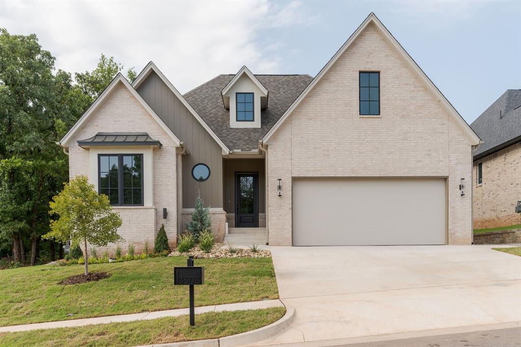 A modern European home that pairs classic French Country influence with clean, contemporary design. Offering three bedrooms, two bathrooms, and a versatile pocket office, the layout is both functional and inviting. The kitchen is a true focal point, featuring a custom plaster vent hood framed with accent tile, adding texture and warmth to the space. The living room has soaring ceilings and is centered around a fireplace and windows overlooking your wooded backyard. Just off the main living areas, the pocket office provides the perfect tucked-away spot for work, planning, or managing daily life. The primary suite feels like a private retreat, highlighted by beams and a charming chandelier. The primary bath features basketweave tile, an elegant arched shower and a soaking tub designed for unwinding at the end of the day. Two additional rooms share a hallway bath that pairs glossy blue tile with a dark stone countertop, and statement turned-wood mirror.. The back porch is the cherry on top- caulted cielings and plenty of space to entertain or lay back with a good book and a glass of wine on a quiet evening. Every detail in this home was designed to balance style, comfort, and character—creating a space that feels both elevated and easy to live in.