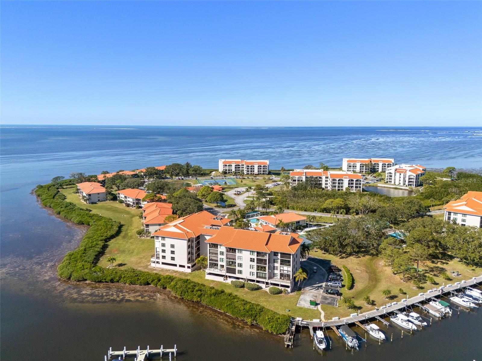 Under contract-accepting backup offers. The perfect Florida second home awaits. Welcome to 1810 Mariner Dr #308 in Tarpon Cove, a private 24/7 guard-gated waterfront community designed for effortless, maintenance-free living. This residence offers stunning Gulf and marina views, creating a serene coastal retreat you’ll enjoy from the moment you arrive.Wake up to water views from the living area, primary bedroom, and balcony—ideal for morning coffee or sunset relaxation. The home features  tile flooring throughout, fully furnished and impact windows (2025) for peace of mind while you’re away. Fully suited for seasonal enjoyment, this is a true lock-and-leave opportunity. This is also a perfect place to call home if you prefer to make this your primary residence.Boating enthusiasts will love immediate Gulf access with  boat slip rentals available—where the marina opens directly to open water. Spend your time exploring islands, cruising at sunset, or simply unwinding along the waterfront.Resort-style amenities include a heated pool and spa, fitness center, tennis courts, clubhouse, and scenic walking paths, with exterior maintenance included. Ideally located minutes from beaches, the Pinellas Trail, Innisbrook Golf Resort, and charming downtown Tarpon Springs. An exceptional second-home opportunity offering Gulf views, boating access, and carefree Florida living.