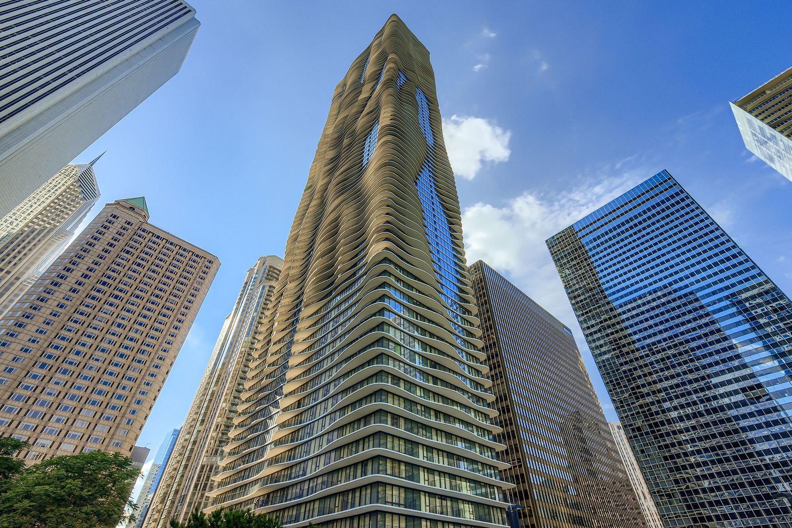 Experience Luxury Living in the Heart of Chicago. Welcome to this stunning and rarely available 2 Bedroom, 2 Bathroom condo on the 61st floor of the iconic Aqua Building in Chicago's coveted Lakeshore East neighborhood. This unit features an amazing wrap around balcony that offers breathtaking views of the Chicago River, Lake Michigan and Millennium Park. The home offers a split bedroom floor plan, open concept kitchen with stainless steel appliances, quartz countertops, custom cabinetry and breakfast bar, and combined living room and dining room with floor to ceiling windows.  The Primary Suite features a large walk-in closet, separate soaking tub and shower and double bowl vanity.  Additional highlights include in-unit laundry, ample custom outfitted closet spaces, and beautiful hardwood flooring. Enjoy your expansive private balcony, perfect for soaking in breathtaking sunrise and sunset views. Residents at the Aqua Building enjoy outstanding amenities, including a state of the art fitness center, indoor and outdoor pools, a basketball court, a 1/4-mile running track, and a sundeck with cabanas. The building is conveniently connected to the Pedway, providing easy access to nearby attractions. Located just steps from Millennium Park, Michigan Avenue, and the lakefront, this property offers the ultimate luxury lifestyle. Deeded parking space is available for additional $50,000.  Welcome Home!