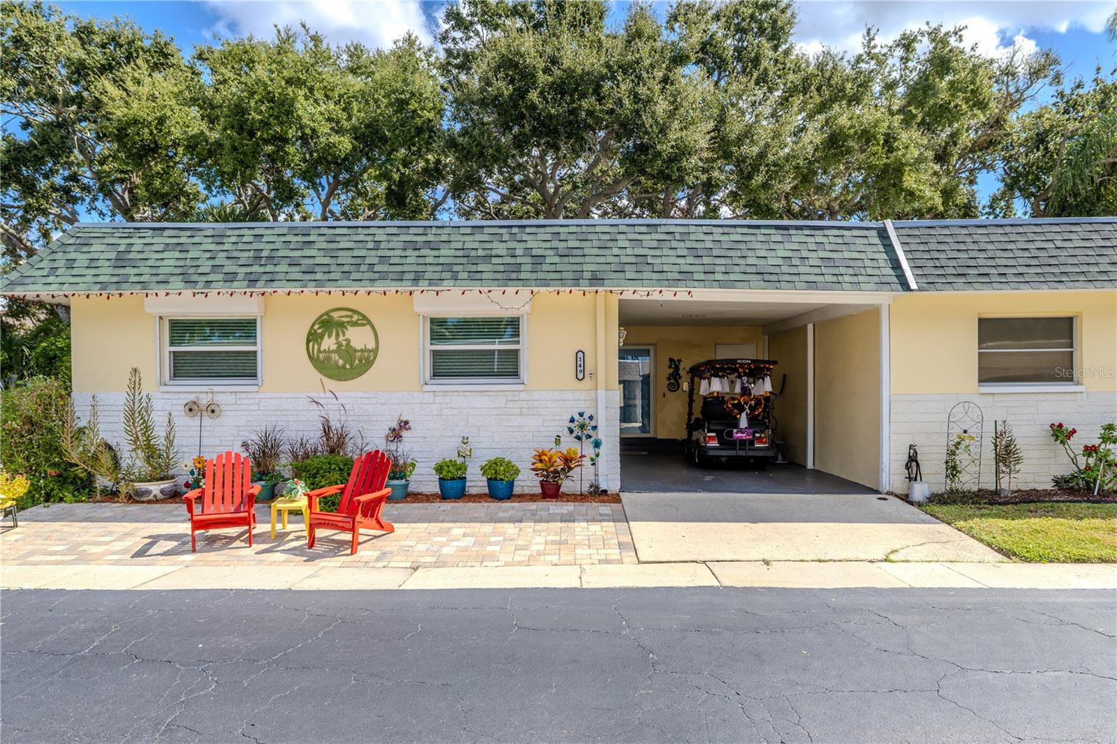 Welcome to this beautifully cared-for 2-bedroom, 2-bath end-unit villa in the sought-after Skye Loch Villas community of Dunedin. Step in from the covered carport and you’ll immediately feel at home in the spacious living room, where soft carpet, warm natural light, and a calm neutral palette create a setting made for both comfort and connection. This inviting main space is perfect for quiet evenings or casual gatherings and flows naturally into the dining area, where large windows frame garden views and bring the outdoors in.

The kitchen sits just beyond, offering both practicality and charm. With generous cabinetry, tile flooring, and a convenient pass-through that keeps the layout open, this space makes everyday living easy. A nearby pantry and extra closet provide valuable storage, while the bright finishes make it feel welcoming and timeless.

Down the hall, both bedrooms are positioned for convenience and privacy from the main living area. The guest bedroom is light and comfortable, with ample closet space and easy access to the updated hall bath featuring a sleek vanity, fresh tilework, and a tub-shower combination that feels modern and functional. The primary suite sits just beyond, offering a peaceful retreat with plush carpet, a spacious walk-in closet, and an ensuite bathroom with a walk-in shower, tiled walls, and a recessed storage nook discreetly built behind the door, ideal for linens and essentials.

At the back of the home, a versatile bonus room extends the living space and connects directly to the outdoors. This flexible area can serve as a cozy reading lounge, creative studio, or laundry space, with direct access to the screened patio just beyond. The covered, tiled enclosure is perfect for enjoying a quiet morning coffee or relaxing in the shade, while the adjoining open patio invites you to unwind under the sky or share a meal alfresco.

Practical updates ensure lasting peace of mind, including a 2018 roof and impact-rated windows and exterior door added in 2020 for durability and efficiency.

Skye Loch Villas is a welcoming 55+ community where residents enjoy a relaxed Florida lifestyle complete with a sparkling pool, shuffleboard courts, and a clubhouse for social gatherings. The location is unmatched, just minutes from charming downtown Dunedin, the Pinellas Trail, and beautiful waterfront parks.

Schedule your private showing today and experience a home that perfectly blends comfort, character, and convenience in one of Dunedin’s most cherished communities.