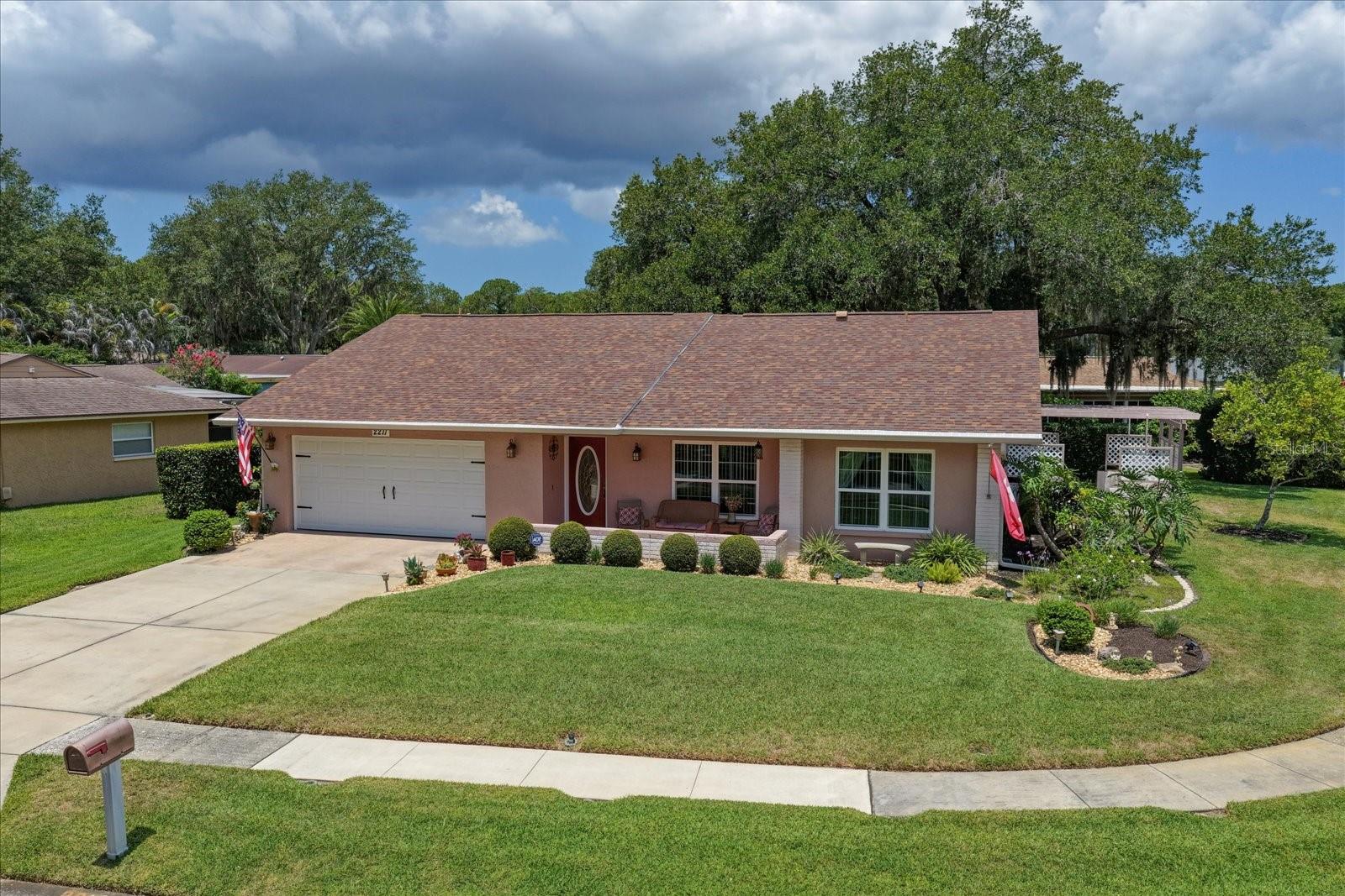 Welcome to the highly sought-after Anchorage of Lake Tarpon, nestled within the desirable East Lake Corridor. This well-established 55+ active adult community is surrounded by natural beauty, mature landscaping, and abundant wildlife, creating a peaceful setting you'll love coming home to. Situated on a beautifully landscaped corner lot, this meticulously maintained, move-in-ready 2-bedroom, 2-bath home with a spacious 2-car garage offers timeless Florida charm.From the moment you arrive, the inviting curb appeal, covered front porch and lush landscaping make a lasting impression. Step inside to discover a bright, welcoming interior filled with natural light and a thoughtfully designed floor plan that balances formal and casual living spaces.The spacious formal living room features a large picture window that brings the outdoors in, while the adjacent formal dining room is perfect for holiday gatherings and entertaining. The kitchen offers ample cabinetry, generous counter space, Samsung SS appliances. A casual nook provides the ideal setting for morning coffee and everyday meals.The kitchen flows seamlessly into the cozy family room, creating a second living area where family and friends can gather. An informal dining space between the kitchen and family room is perfect for playing cards or game night and has access door to the outdoor living space.  Adding to the home's functionality is a true inside laundry room complete with cabinetry, and a utility sink.The split-bedroom floor plan offers privacy for both owners and guests. The spacious primary suite is at the rear of the home and features a large walk-in closet and updated ensuite bath with a walk-in shower, tile from floor to ceiling, and wood cabinetry. A split plan, guests will enjoy a secondary bedroom at the front of the home and a full hall bath.One of the home's desirable features is its indoor-outdoor living design. The expansive pergola covered patio is accessible from the family room, and kitchen, creating a natural extension of the living space, overlooking the beautifully landscaped yard, providing the perfect spot for al fresco dining and entertaining.The oversized 2-car garage offers abundant storage.  Major updates provide peace of mind, including a new roof (2024), A/C (2016) with new coil (2025), and water heater (2025).Life in Anchorage of Lake Tarpon extends far beyond your front door. Residents enjoy a remodeled clubhouse and community pool just a block away. The clubhouse features a library, pool table, kitchen, gathering spaces, and a full calendar of social activities.Outdoor enthusiasts will appreciate the community's prime location adjacent to the Pinellas Trail and 250-acre John Chestnut Sr. Park. A private neighborhood walkway provides direct access to Lake Tarpon's boat launch, walking trails, dog park, playground, and scenic natural surroundings. The community is pet-friendly, and golf cart friendly.Conveniently located along the East Lake corridor, near the YMCA, premier golf courses, shopping, dining, and medical facilities, this home is also just 20 minutes from award-winning Gulf beaches, Tampa International Airport, professional sports venues, Ruth Eckerd Hall, and the shops and waterfront charm of downtown Dunedin.This is a rare opportunity to enjoy a classic Florida home in a welcoming, nature-rich community where neighbors become friends, and every day feels like a vacation.  NOT IN A FLOOD ZONE.