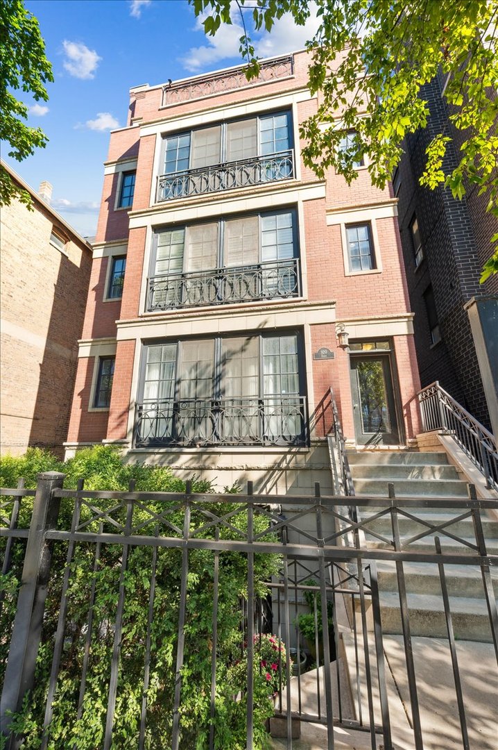 Nestled in the heart of East Lakeview on an expansive 34 ft lot, this magazine-worthy 3 bedroom/2 bathroom penthouse spanning 2,000 sqft awaits! With its extra-wide layout, this home lives like a single-family residence - all on one level - offering three private outdoor spaces, each newly finished with Trex decking, including a full roof deck expanded to utilize every inch of space. As you step inside, you'll be captivated by the abundant natural light streaming through the south-facing windows and front balcony overlooking lush, tree-lined Barry Avenue. The sunlit open living area features a gas fireplace and flows seamlessly into the designated dining space, accented by a beautiful light fixture. Whether you're enjoying dinner with the crisp fall breeze drifting in or cozying up by the fireplace on a winter evening, this space is designed for both comfort and functionality. The chef's kitchen showcases a peninsula island with updated quartz countertops, sleek white subway tile, new modern hardware and lighting fixtures, high-end SubZero and Viking stainless steel appliances, and a coveted pantry. Tucked away at the end of your charming arched hallway you'll find your primary suite, a true retreat enhanced by a peaceful balcony that extends your living space outdoors. Impressively spacious, it easily fits a king-sized bed, nightstands, dressers, chairs, and more! Enjoy the luxury of a huge professionally designed walk-in closet and a spa-like en-suite bathroom featuring heated floors, dual vanities, a soaking tub, and a steam shower with seating.  Your second bedroom is generously sized with French doors, ample closet space, and versatility for a queen bed or a stylish home office. Your third bedroom also easily accommodates a queen-sized bed and offers plentiful closet space. Your second bathroom boasts a newly installed glass shower door, and across the hall you will find your laundry closet highlighting a newer side-by-side washer/dryer with additional storage and a convenient coat closet. If that's not enough, stairs lead you up to your massive exclusive roof deck oasis - an ideal setting for entertaining, family meals, or simply relaxing while enjoying sweeping views of the city. Additional highlights include resurfaced and stained hardwood floors throughout, newer mechanicals (AC & Furnace 2019; Water Heater 2024), an attached garage parking space off a heated sloped driveway, and a generously sized personal storage closet in the basement. This intimate building also offers low assessments and a proactive association with healthy reserves. All of this in an A+ location close to Southport Corridor, two L stops, the lake, Mariano's, Whole Foods, Amazon Fresh, Wiggly Field Dog Park, restaurants, shops, playgrounds, and more. Don't miss the opportunity to own this truly special home!