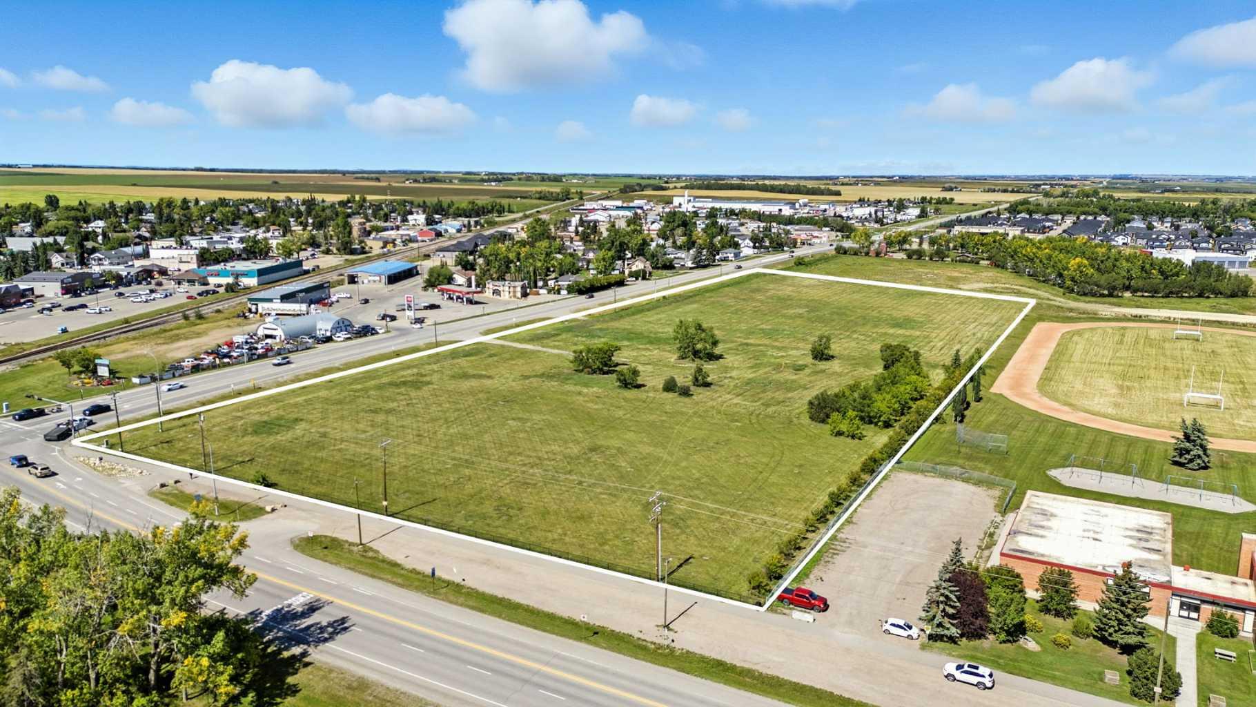 Prime 11.27 acre development site at the intersection of Highway 581 and Highway 2A in Carstairs. Offered on two titles and zoned C-2, this property is suited for a wide range of commercial opportunities including retail, office, medical, and professional services, with discretionary uses allowing for gas stations, hotels, car washes, and entertainment facilities. The location benefits from excellent visibility with more than 8,900 vehicles passing daily, positioned beside the school and across from established commercial areas.Carstairs is one of Alberta’s fastest-growing communities, with over 30% population growth since 2016 and continued expansion fueled by new residential developments and in-migration from Calgary, just 30 minutes to the south. The town’s strong family demographic, increasing demand for local services, and proximity to major highways make this property an ideal choice for developers and investors seeking long-term opportunity in a thriving market. With bare land ready for development and zoning that supports a diverse range of commercial uses, this site offers unmatched potential in the heart of a growing corridor.