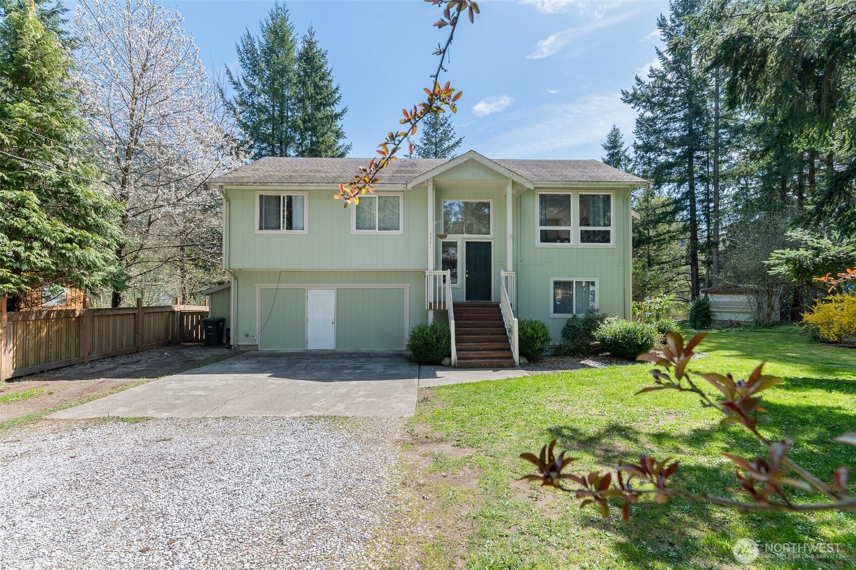 Rare, gorgeous LAKE front home on DOUBLE LOT! Upstairs find a large living room complete with gas fireplace, dining room with sliding glass door to deck, and kitchen with island. You will also find three bedrooms & two full bathrooms including the primary suite. The lower level also has a bedroom, living room, full bathroom, and second kitchen! Lower level can be a separate apartment! The double lot includes a greenhouse, chicken coop, outbuildings, garden space, fruit trees, blueberry & raspberry bushes, and a nut tree. New toilets, water heater, and washer. Heat pump for efficient heating and air cooling! The trailer can stay with property for more living space or visitors. Rare 5 bedroom septic. Absolutely gorgeous lake views year round!