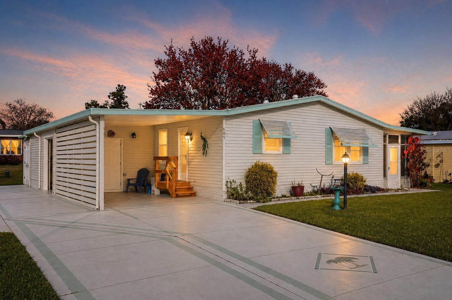 NO BOND! OFFERED TURNKEY! Perfectly situated in the desirable Orange Blossom Gardens community, this charming 2 Bdrm/2 Bath home is just moments from Silver Lake Recreation Center and a short golf cart ride to Spanish Springs Town Center. Step inside to a bright, open floor plan designed for both comfort and functionality. The sun-filled kitchen features stainless steel appliances, a breakfast bar, and ample cabinet and counter space—ideal for everyday living or entertaining. The spacious Great Room seamlessly combines the dining and living areas, while sliding doors lead to an enclosed lanai with sliding plexiglass windows—perfect for enjoying your morning coffee or unwinding in the evening. The guest bathroom has been beautifully upgraded and is handicap accessible with a walk-in shower, and the primary suite offers double-door entry, a walk-in closet, and a private ensuite bath. Updated FHA-compliant tie-downs provide added peace of mind, and double-pane windows enhance energy efficiency throughout the home. Additional features include a spacious indoor laundry room with extra storage, an attached golf cart garage with opener, an attached outside storage room, and a covered carport. This move-in ready home combines comfort, convenience, and location—schedule your showing today!