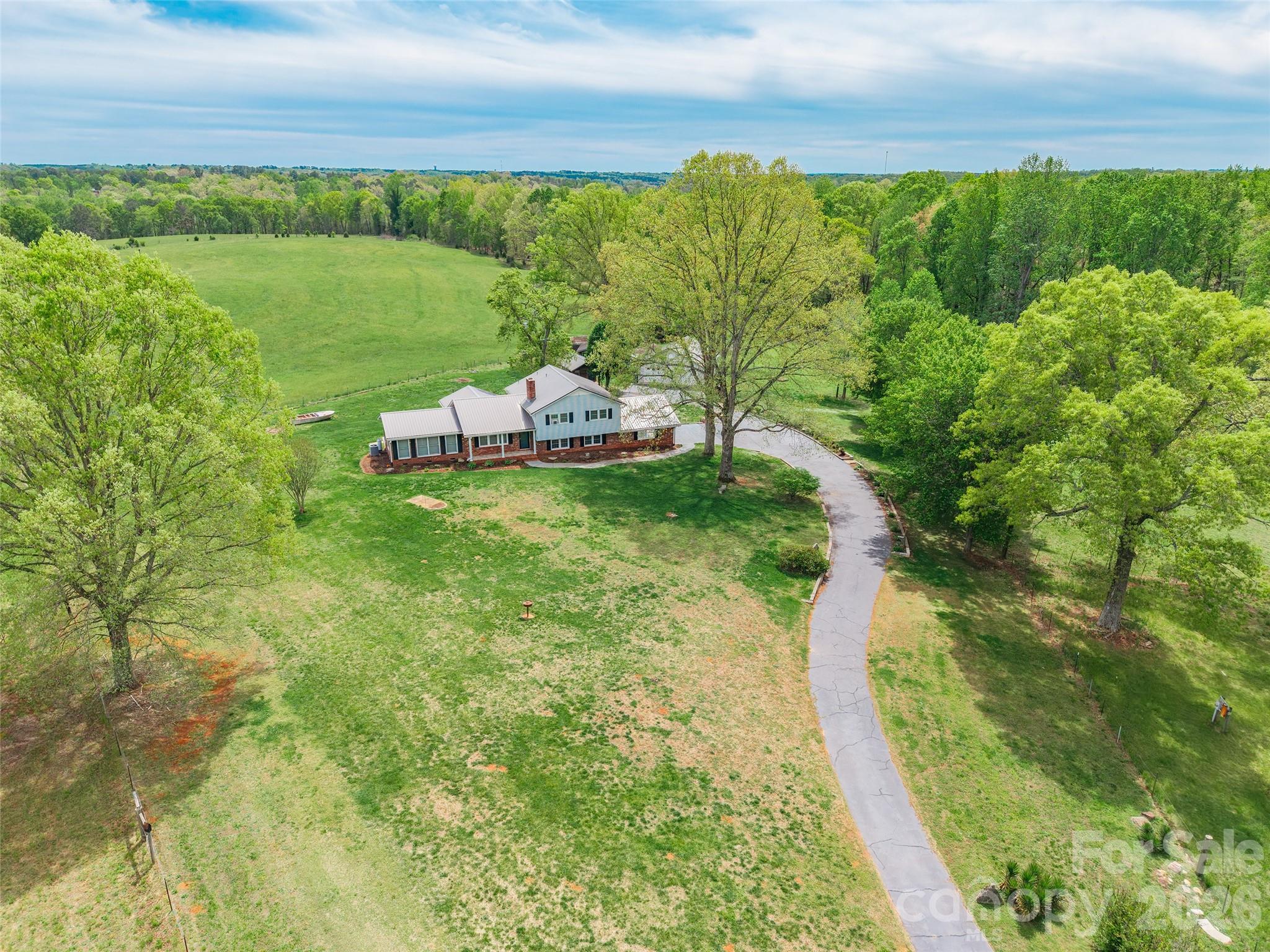 Tucked away at the end of a quiet street in Mayo, SC, this one-owner property offers a rare combination of privacy, space, and potential. Situated on 5 acres, the land features a peaceful pond along with multiple outbuildings, a 2-car carport, and a 2-car garage—ideal for storage, hobbies, or equipment.The home includes updated central HVAC on the main and lower levels, while the upper level is equipped with ceiling heat. A durable metal roof adds long-term value and peace of mind.With its serene setting and versatile features, this property is perfect for those seeking a private retreat with room to grow.Property is being sold by a family member. Information provided is deemed reliable but should be verified by buyer.