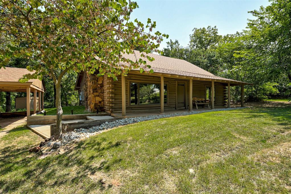 Experience this phenomenal four bedroom log cabin set on 3.33 scenic acres in Edmond, offering the perfect blend of peaceful country living and proven income potential. Spanning 2,320 square feet, this authentic cabin has been a highly successful Airbnb for the past four years, averaging approximately $5,500 per month in rental income with peak months reaching as high as $6,929. Inside, the home welcomes you with an open living area highlighted by soaring cathedral ceilings, exposed wood beams, and expansive windows that flood the space with natural light. A striking stone fireplace anchors the room, creating a warm and inviting atmosphere, while the kitchen delivers modern conveniences wrapped in rustic charm. All four bedrooms are thoughtfully designed to provide comfort, character, and privacy for guests or full time living. Step outside to enjoy the large covered porch, ideal for morning coffee or evening sunsets, overlooking abundant wildlife and serene surroundings. The stocked pond sits at the heart of the property, offering a relaxing backdrop for fishing or quiet reflection. Whether you are looking for a primary residence with income upside, a short term rental investment, or a weekend retreat that pays for itself, this property delivers. All furniture and everything you see in the house stays! Rarely does a home combine this level of natural beauty, privacy, and established cash flow. Opportunities like this do not come along often. DO NOT APPROACH THE HOME OR DISTURB TENANTS. THIS IS AN ACTIVE AIRBNB. LISTOR SHOW ONLY, THANK YOU!
