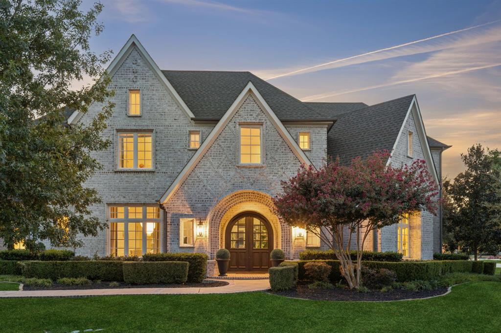 Set on a beautifully landscaped 1.07-acre corner lot in Tranquility Farms, an intimate enclave of approximately 46 estate home sites in highly regarded Lovejoy ISD, this custom Ron McHam estate blends sophisticated interiors with resort-style outdoor living. Seven total bedrooms, seven full baths, one half bath, a separate guest house, and an oversized four-car garage offer exceptional space and versatility.Arched double doors open to rich hardwood floors, refined architectural details, and a gracious living room with a coffered ceiling and statement fireplace. The gourmet kitchen features a generous island with integrated dining, gas range, built-in refrigerator, and separate prep kitchen. A formal dining room and wet bar make entertaining effortless. The secluded downstairs primary suite features a spa-inspired bath with dual marble vanities, freestanding tub, oversized shower, and custom closets with private laundry. Each secondary bedroom includes an ensuite bath. A private downstairs study with pocket doors provides a quiet retreat for work or meetings, while a media and game room, upstairs loft, and additional laundry room enhance everyday living.A sparkling pool and spa, expansive grounds, and covered outdoor living areas with electric retractable screens create an inviting setting for relaxing and entertaining. The separate 999 SF guest house features its own kitchen, living area, bedroom, bath, and laundry, offering flexibility for extended stays or multigenerational living. The oversized four-car garage provides ample room for vehicles and storage.Enjoy convenient access to US 75 and the Sam Rayburn Tollway (SH 121), plus nearby shopping, dining, and entertainment at Fairview Town Center and The Village at Allen. Historic Downtown McKinney’s boutiques, local restaurants, and charming town square are within an easy drive.