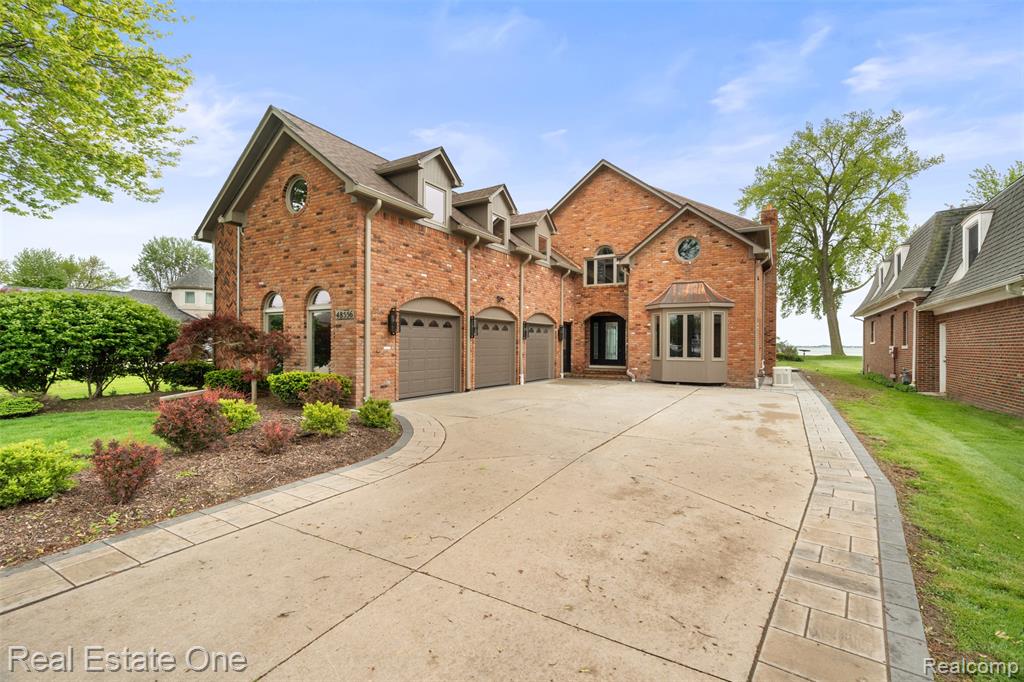 Waterfront Luxury on Anchor BayThis stunning Lakefront and canal-front home offers direct backyard access to the water, complete with a private dock and boat hoist—perfect for lake living. A beautifully updated brick exterior welcomes you with brand-new windows, front and garage doors, modern lighting, and an extended driveway. Step inside to find marble flooring throughout the first level, a spacious open layout, and a first-floor primary en suite featuring a walk-in shower and custom California closet. The living room featuring floor-to-ceiling windows overlooking Anchor Bay and an electric fireplace, while the dining area includes an additional fireplace and built-in TV. The chef’s kitchen is equipped with top-of-the-line Viking appliances, including a range, counter depth refrigerator, dishwasher, microwave, warming oven, and a large island with a prep sink. A stylish half bath and first-floor laundry add convenience. Upstairs, you’ll find two generously sized bedrooms with brand-new plush carpeting, and a second luxurious primary en suite with a private balcony, California closet, double vanity, two-person shower, soaking tub, and separate water closet.
Additional highlights include a whole-house generator, solid core doors throughout, a three-car attached garage with epoxy flooring, access to a large bonus room above, and a deep, clean concrete crawl space—ideal for storage and peace of mind.