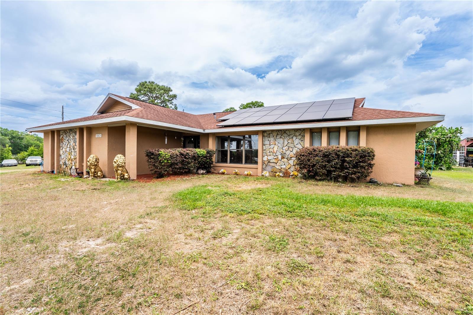 Welcome to your private haven, within a FOUR-MINUTE drive from The World Equestrian Center. This stunning 6.6+ acre flag lot masterfully combines privacy and convenience, enveloped by mature trees and fully fenced for your peace of mind.

Step inside this beautifully appointed three-bedroom, two-bathroom home, built in 1991, featuring an inviting open floor plan that flows seamlessly. Host formal dinners in the airy and open dining room, unwind in the air-conditioned back porch (formerly a fourth bedroom), and enjoy the oversized workshop and RV garage with hookups for all your vehicles and projects. A 3 stall pole barn and A unique air-conditioned shed offers additional storage or a comfortable workspace.

With a recently updated shingle roof, just 8-9 years old, this home ensures both luxury and protection. Nestled in Flood Zone X, this property is a safe haven and an exceptional opportunity for discerning buyers. Don’t miss your chance to claim this exquisite haven as your forever home!