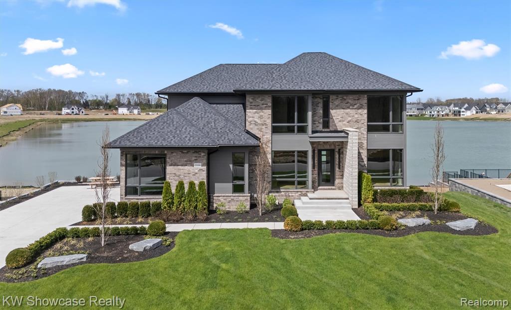 NEW, CUSTOM BUILT BY M ROSE CONSTRUCTION! SPECTACULAR HOME LOCATED IN THE RESERVE AT CRYSTAL LAKE - HBA'S 2025 DEVELOPMENT OF THE YEAR!  THE 40-ACRE LAKE OFFERS SWIMMING, KAYAKING, FISHING, ELECTRIC BOATS, AND OTHER RECREATIONAL ACTIVITIES.  Located among other custom built homes, this move in ready contemporary features a premium brick/stone elevation, convenient second floor Laundry Room, finished Lower Level Walk-out, 3 Car Garage and fully landscaped lot. The desirable Open Concept offers over 5,700 SF of luxurious living space appointed with high quality finishes, an extensive use of glass and premium fixtures throughout. The covered entry leads to a spacious Foyer with rich hardwood flooring flowing into the adjacent Library/Study and Dining Room with a wonderful Butler's Pantry. Uninterrupted site lines and hardwood flooring create the perfect living area comprised of a Great Room, Nook and Kitchen. The Great Room features a granite surround fireplace and a full wall of windows facing the lake. The Dining Nook features a 9' door-wall opening to a sensational covered deck with ceiling fans, fireplace and lake views! The Gourmet Kitchen is furnished with an abundance of custom cabinetry, leathered granite counters, Island/Snack-bar, premium Thermador appliances and walk-in pantry/prep station. The Owner's Suite features a striking step ceiling, crown molding, wall of windows facing the lake, 2 walk-in closets furnished with custom organizers and large Ensuite furnished with a freestanding tub, Euroglas enclosed shower, dual vanities and private toilet room.  Three additional Bedroom Suites include a ceiling fan with light, walk-in closet with custom organizers and private Bath. The sun filled lower level includes a huge Family/Rec Room, door-wall opening to the patio, Quartz Wet Bar with wine cooler, full Bath and Media Room. Oversized 3 car Garage is finished with drywall, paint, epoxy coated floor and insulated overhead doors.