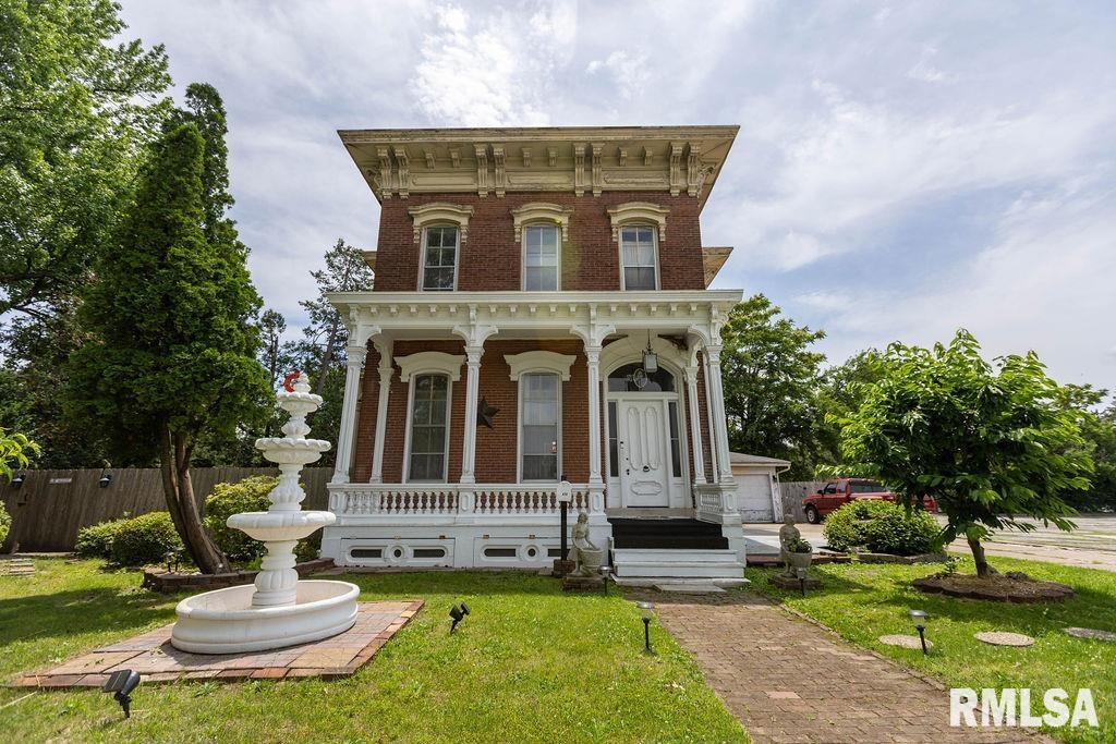 A perfect blend of historic elegance and modern updates! This historical home built in 1872 showcases stunning original character with tall ceilings, oversized windows, decorative fireplaces, intricate ceiling medallions, and beautiful natural woodwork. Sun-filled rooms create a warm and inviting atmosphere while tasteful updates throughout provide modern convenience. The spacious remodeled eat-in kitchen features updated countertops, tile flooring, backsplash, & center island. Bathrooms have been beautifully updated to include modern showers, and tile flooring. Lower level is mostly finished and offers a full bathroom, spacious recreation area and kitchenette.  Upper level consists of 4 spacious bedrooms, 1 with attached full bathroom and large walk-in closet, and another half bath. Primary bedroom with primary bath could be on main level in lieu of the den, or upstairs.  Major improvements include upgraded plumbing and electrical, two furnaces (2018), A/C condenser (2018), and a large-capacity electric water heater (2017). Outside, enjoy the fenced backyard and additional side yard space near the garage. This unique property offers timeless charm, generous living space, and extensive updates throughout. Situated on a corner lot and withing walking distance to downtown activities, you will love where you live!