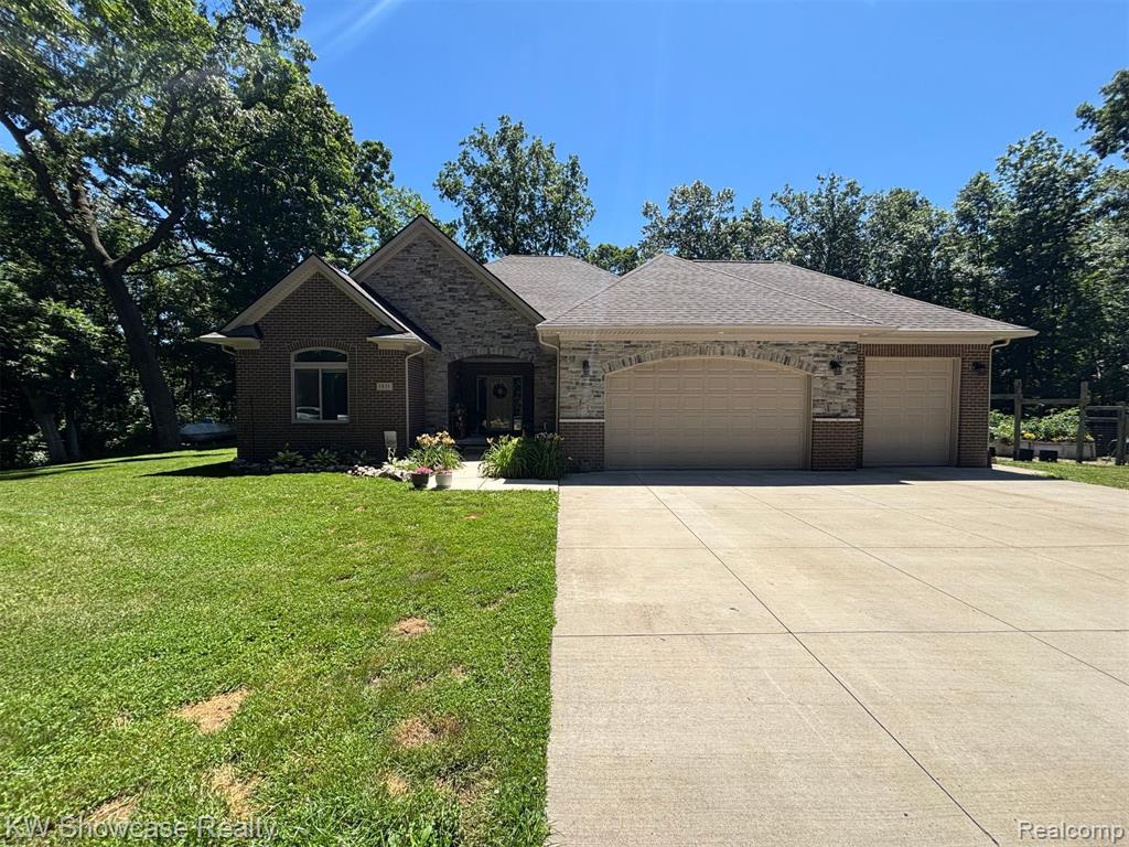 Welcome to this Rare Opportunity to own a meticulously cared-for, one owner home in an excellent location nestled in White lake Twp. on 27 acres. Pulling up the winding scenic driveway, this gem offers incredible curb appeal w/lush landscaping and welcoming presence that sets the tone the moment you arrive. Inside, you're greeted by a spacious living room w/beautiful wood floors, tall ceilings and a cozy fireplace/wood stove. Hosting a dinner? No problem!! The large eat-in kitchen is fully equipped with SS Appliances, gorgeous wood cabinets, and an Island/breakfast bar. From here, you can look out across the open-concept layout and stay part of the conversation and entertain guests. Main Level Primary Suite is like your own private getaway with treetop views, a Tray Ceiling, and plenty of space for a seating area. It also offers, a Walk-in closet and En Suite full bathroom that includes a Double Vanity. Head downstairs and the lower level unfolds like a second home. A massive Recreation room serves as a hub for movie nights or a game room. There's a second full kitchen w/large Marble Island, ample cabinetry, perfect for in-law accommodations, and extended guests. In addition, a Flex Rm, a full bath, second laundry, Workshop, and a large utility rm round out the space. Step outside, the private wooded lot w/half a mile of groomed trails with 3 Hunting Blinds (2 Raised - 1 ground) and fenced in Raised Vegetable Garden area even a beginner can feel like a pro gardener, bringing your homegrown dreams to life with ease along with surrounding trees that create a Natural Oasis just steps from your door while providing added privacy. To see 1831 Hill Rd. in person, schedule a private showing with your favorite agent today.