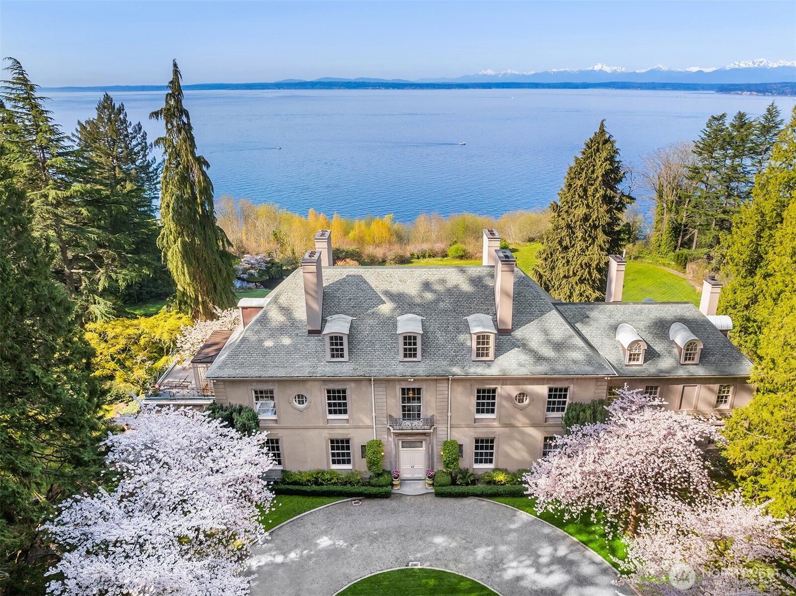 A Georgian Estate by Charles Platt - one of America’s most revered architects - set on 7.26± bluffside acres in the gated Highlands. Regarded as one of the Pacific Coast’s finest examples of Georgian architecture. Inspired by the great country homes of Italy and France, Platt believed that beauty lay in symmetry, clarity, and balance. This estate brings those ideals to life through perfectly proportioned rooms and an effortless flow between architecture and landscape. The home unfolds with quiet drama. A grand, mural-adorned drawing room, paneled library, and formal dining room all frame panoramic views of Puget Sound and the Olympic Mountains. Every detail from soaring ceilings and acanthus-leaf cornices to herringbone hardwoods and a sweeping staircase reflects a profound understanding of classical design and timeless refinement.      Olmsted’s vision of naturalistic beauty is reflected in the grounds. Open lawns stretch toward the bluff, while woodland paths weave through groves of mature trees and sculpted gardens. A tranquil pond anchors the landscape, and surrounding greenery creates a seamless connection between the residence and the land. It is a setting designed for both retreat and discovery. An extraordinary convergence of architecture, landscape and legacy - without precedent in the architectural history of the Pacific Northwest.