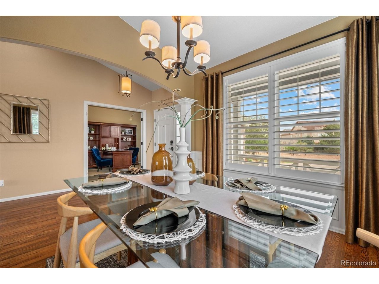 Experience elevated Colorado living in this exceptional ranch-style home perfectly positioned along Spring Valley Golf Club with panoramic fairway views and stunning Pikes Peak sunsets. Every detail has been thoughtfully designed in this former custom model home, from the bright, open floor plan and expansive windows to the high-end finishes throughout. The spacious kitchen is the centerpiece of the home, offering premium cabinetry, granite countertops, stainless steel appliances, double ovens, and generous space for gathering. A private office, elegant dining area, and inviting great room create a layout that is equally suited for everyday living and entertaining. The luxurious primary suite features a spa-inspired bath, while two additional bedrooms and a full bath complete the main level. The finished lower level expands the home's versatility with a large recreation space, theater area, wet bar with kitchenette, guest suite, 2 bathrooms, and abundant room for hosting family and friends. Step outside to a peaceful backyard retreat where indoor and outdoor living blend effortlessly. Enjoy the covered patio, outdoor kitchen, hot tub, fire pit, and beautifully landscaped grounds, all overlooking the golf course. Permanent exterior lighting provides year-round curb appeal, while a concrete walkway offers convenient access to the backyard. Additional updates include a new roof and exterior paint completed in 2024, making this meticulously maintained property as practical as it is beautiful. With its premier golf course setting, exceptional outdoor living on 1/2 an acre, and ease of living inside, this is an opportunity to own one of Elizabeth's most desirable homes.