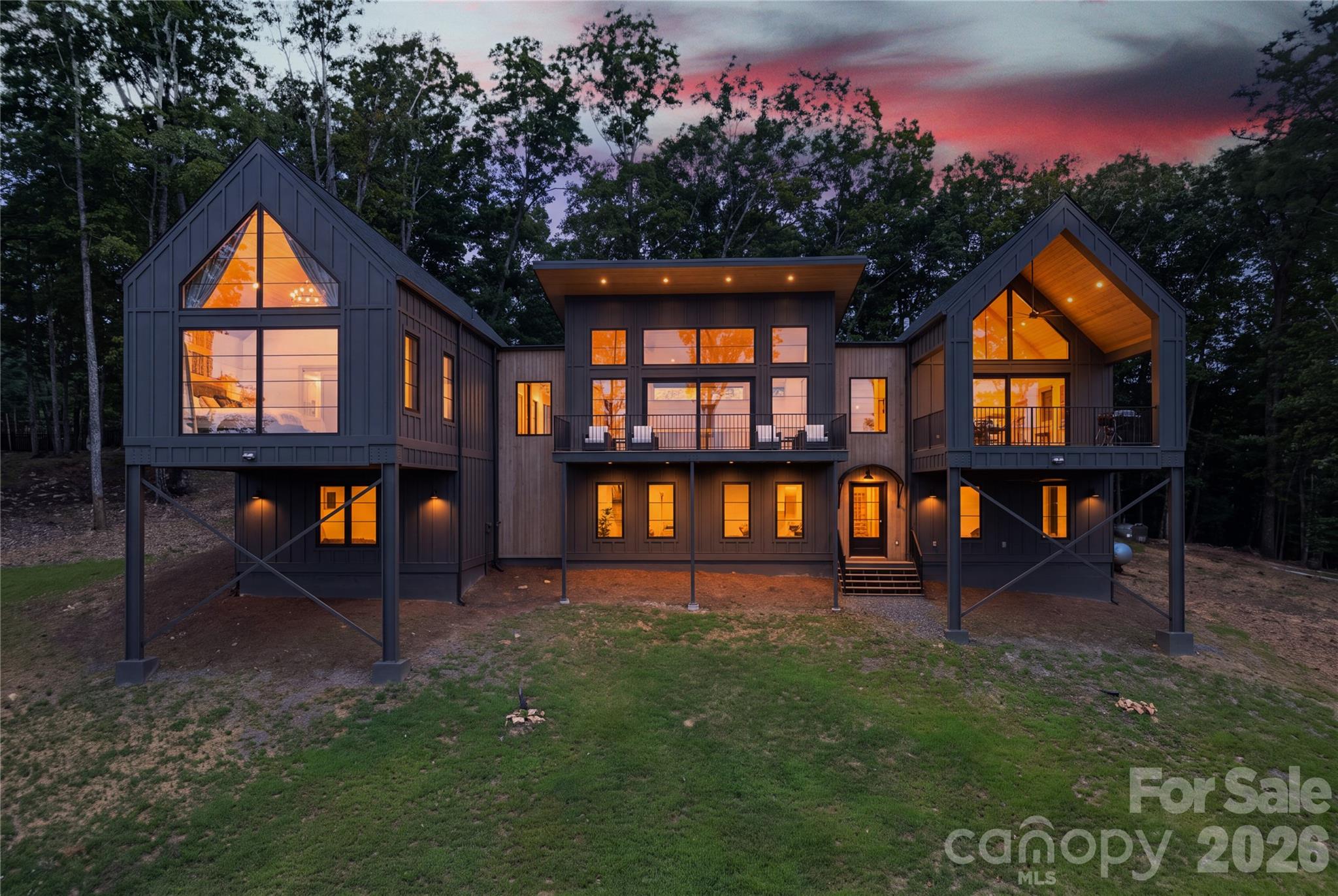 A must see home with expansive views that photos do not do justice. Completed in 2025, this stunning 3-bedroom plus an additional room that could be a bedroom or office, 3.5-bath luxury mountain home sits on 1.38 acres at the top of a private ridge in Brasstown, NC. With 4,554+/- SF of heated living space, 560 +/- SF of covered porches, and a 2-car garage, the home offers exceptional space for family and entertaining. With two bedrooms with en-suites on the main level, including the primary, this home makes it easy to age in place. Expansive windows and glass doors showcase long-range layered mountain views and spectacular western-facing sunsets. The open-concept interior features soaring cedar tongue-and-groove ceilings, wide-plank flooring, custom oak cabinetry, Taj Mahal quartzite, and high-end Bosch appliances. The main-level primary suite includes vaulted ceilings, a private loft, a large walk-in closet, and a spa-like bath with a soaking tub and curb-less dual-head shower. The lower level provides two additional bedrooms, a full bath, a large recreation room, TV area, pool table, ping-pong table, kids' play area, and a kitchenette.Multiple covered outdoor living spaces create an ideal setting for mountain-view dining, grilling, relaxing, and entertaining. High-end construction and features include spray-foam insulation, four-zone HVAC, tankless water heater, fiber internet, security cameras, 400-amp service, and an EV charger. The property offers easy access to Lake Chatuge, golf, trout fishing, hiking, rafting, Brasstown Bald, Helen, mountain restaurants, and regional attractions.