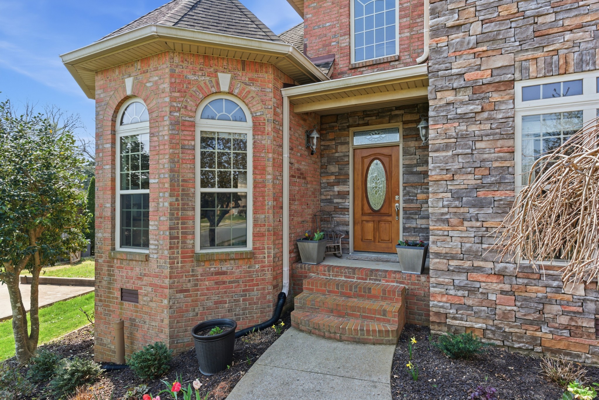 Welcome to this well-maintained all-brick home situated on a spacious lot just shy of half an acre. Offering 4 bedrooms and 3 full bathrooms, this home features a functional and versatile layout designed for everyday living. The main level includes a primary suite with an ensuite bath featuring a separate shower, soaking tub, and dual closets. An additional bedroom on the main level provides flexibility for a variety of uses. You’ll also find a formal dining room, an eat-in kitchen complemented by custom built cabinets that add both style and functionality., and a comfortable living room with a gas fireplace. Upstairs offers two additional bedrooms, a full bathroom, and a bonus room, along with an extra large attic storage area conveniently located behind the upstairs bedroom. Energy-efficient argon windows enhance comfort throughout the home. The outdoor space is equally inviting, featuring mature landscaping, flowering plants, and trees that create a beautiful setting throughout the seasons. Enjoy added convenience with an automated lawn sprinkler system and enhanced curb appeal with outdoor spot lighting on the front of the home, along with plenty of room to enjoy the privacy and space of the large lot. Conveniently located near Exit 11 with easy access to Clarksville’s shopping, dining, and amenities, this home is move-in ready and offers a great combination of space, comfort, and location.