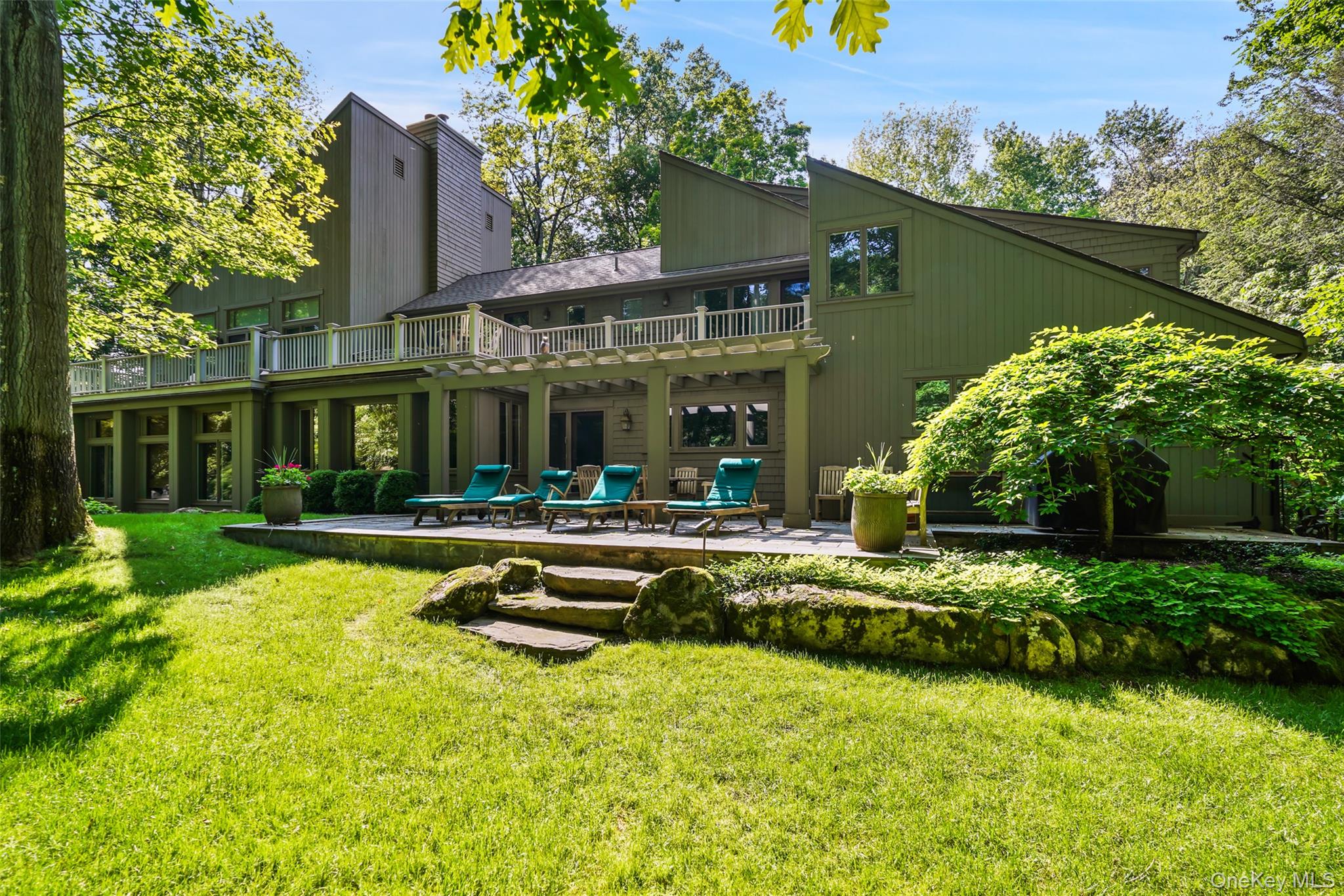 Fabulous Country Retreat. Absolute serenity! Long drive through scenic woodlands to peaceful privacy. Fabulous high site with glorious sunset views. Beautifully landscaped grounds with an array of fine and flowering plantings, fenced for deer. Free-form Swimming Pool with spa and two waterfalls. Perfectly positioned Tennis Court. Architect-designed Country House with contemporary and traditional elements. Stunning interior spaces with beautifully scaled rooms, vaulted ceilings and walls of windows. Exceptional craftsmanship with substantial millwork, wide board oak floors and high-end finishes. Nearly 5700 square feet of finely appointed living space. Fabulous open floorplan with impressive main rooms for entertaining. Chef’s Kitchen with center island, custom cabinetry, marble counters and high-end appliances. Five Bedrooms include a spectacular Primary Suite with Dressing Room, Office, Gym and Two Baths. Lower level Recreation Room. The ultimate  estate for the most discerning buyer.